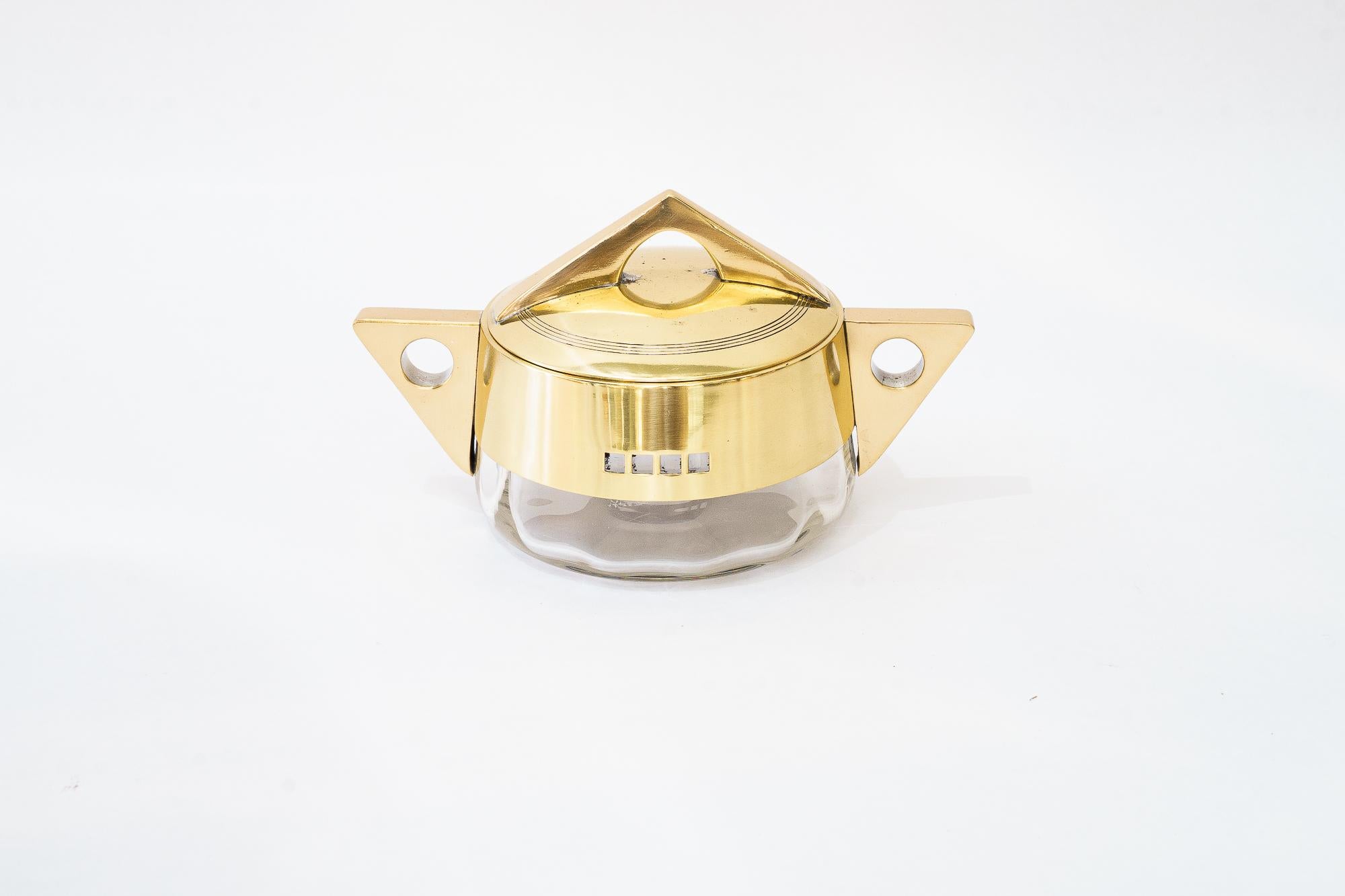 Sugar bowl made of brass and glass. Design by Jutta Sika. Around 1910.  Stamped Argentor; Jutta Sika was a member of the Wiener Werkstätte and a founding member of the Austrian Werkbund.

