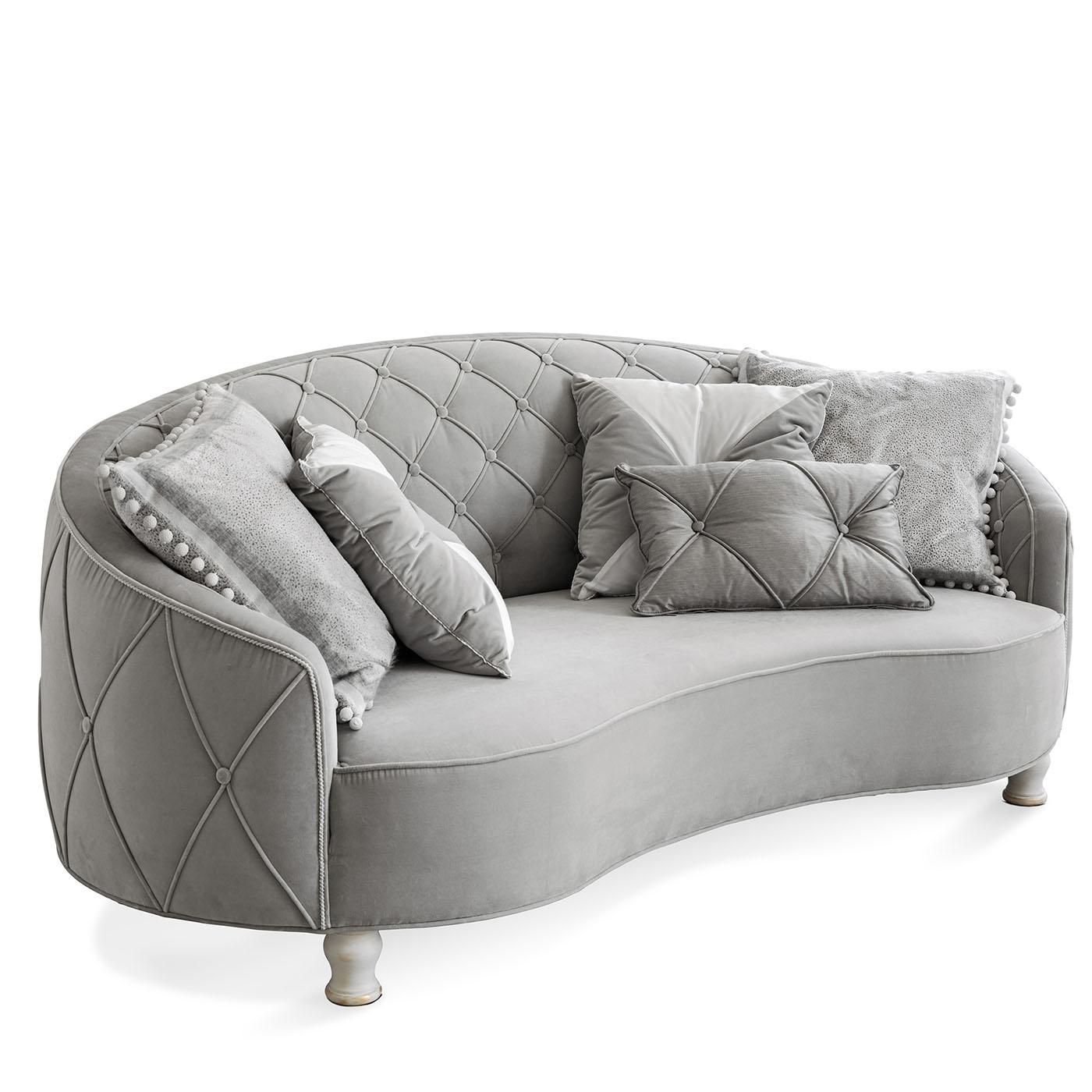 Two-seater sofa with quilted bottom capitonnè, upholstered with cotton velvet, wooden feet in white finishing. Pillows included as per the photo.