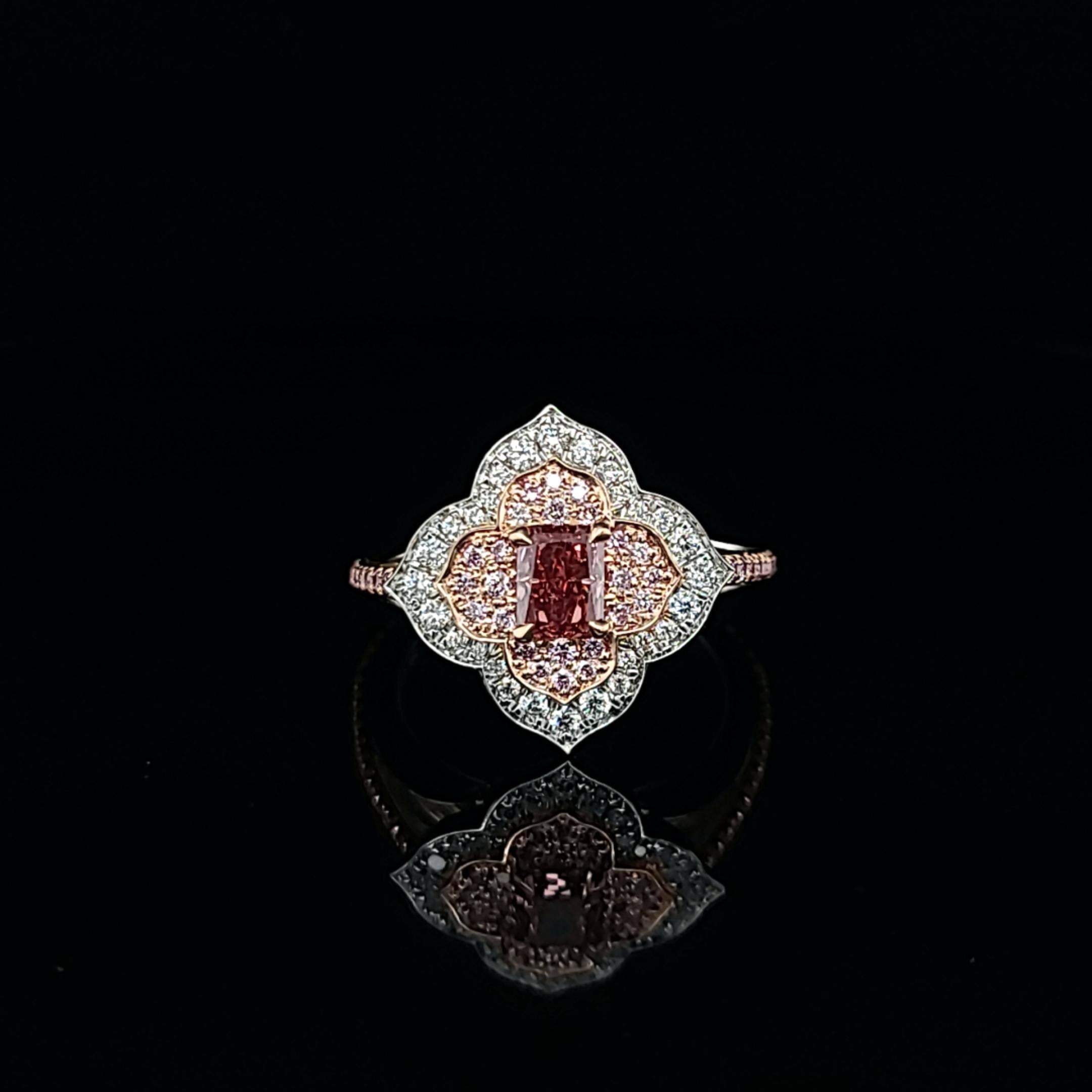 Make an unforgettable statement with our exquisite handmade ring showcasing an extraordinary Argyle fancy deep orangy pink radiant diamond. This remarkable center stone, certified by GIA with the reference number 2215082302 and bearing the