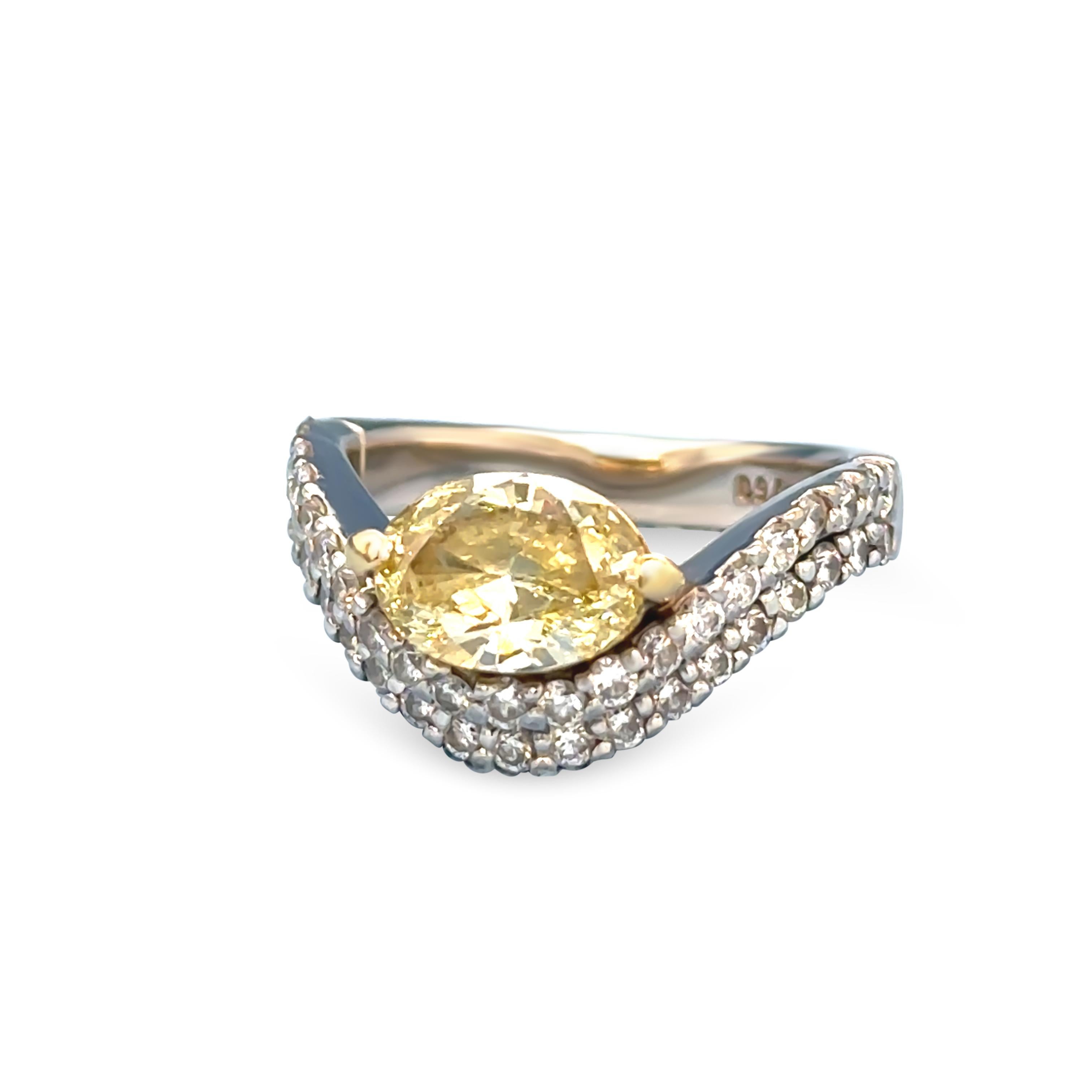 An Argyle Diamond 18ct White gold and Yellow gold set ladies diamond ring. The ring features a central Marquise cut fancy diamond end set in yellow gold within the inner section of a two tier U shaped shank. Each tier having 21 and 19 diamonds