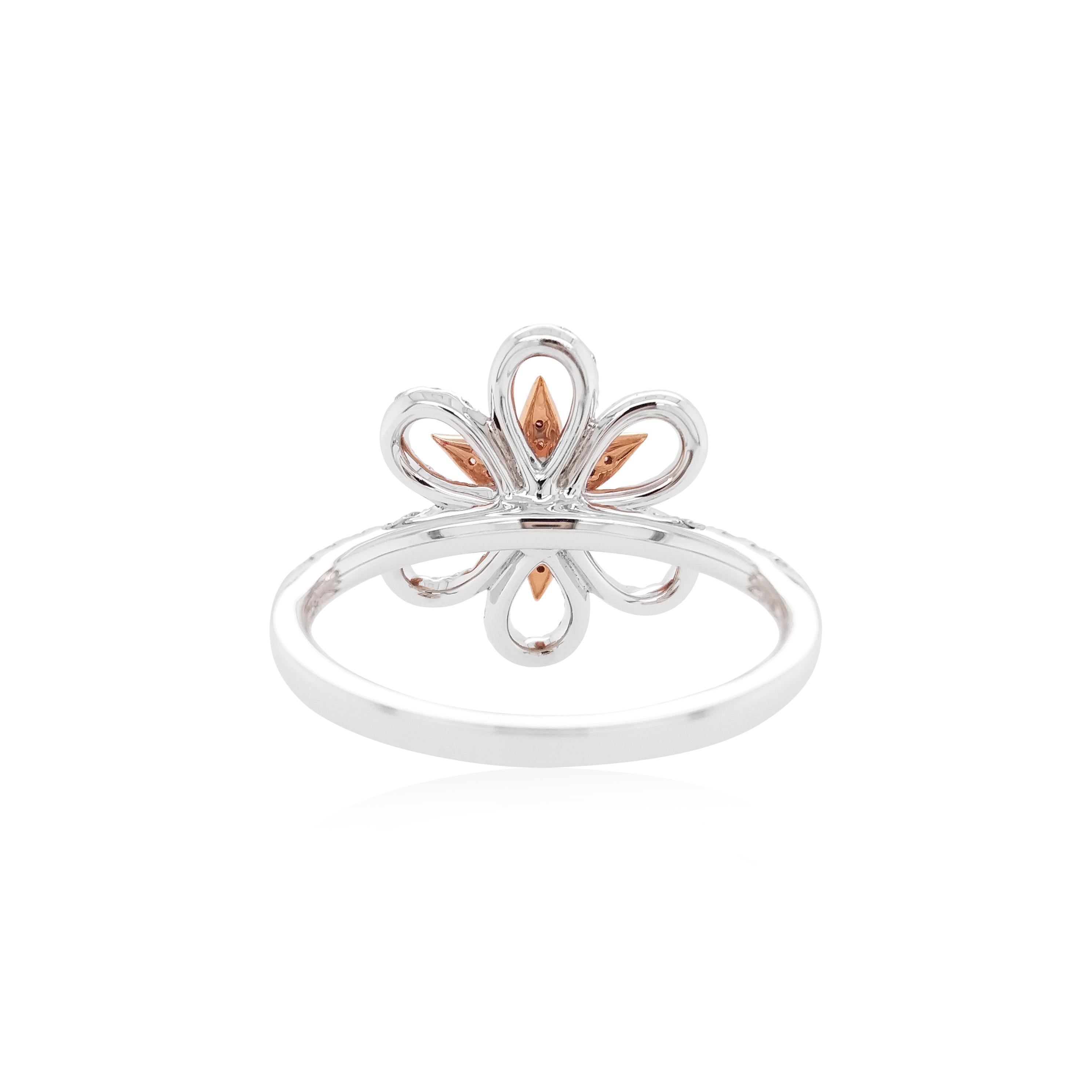 This mesmeric platinum ring features natural Argyle pink diamonds at its forefront, accentuated by the white diamonds floral motif which surrounds it. Bold, yet intricate, this one-of-a-kind ring will add a sumptuous touch of colour to your