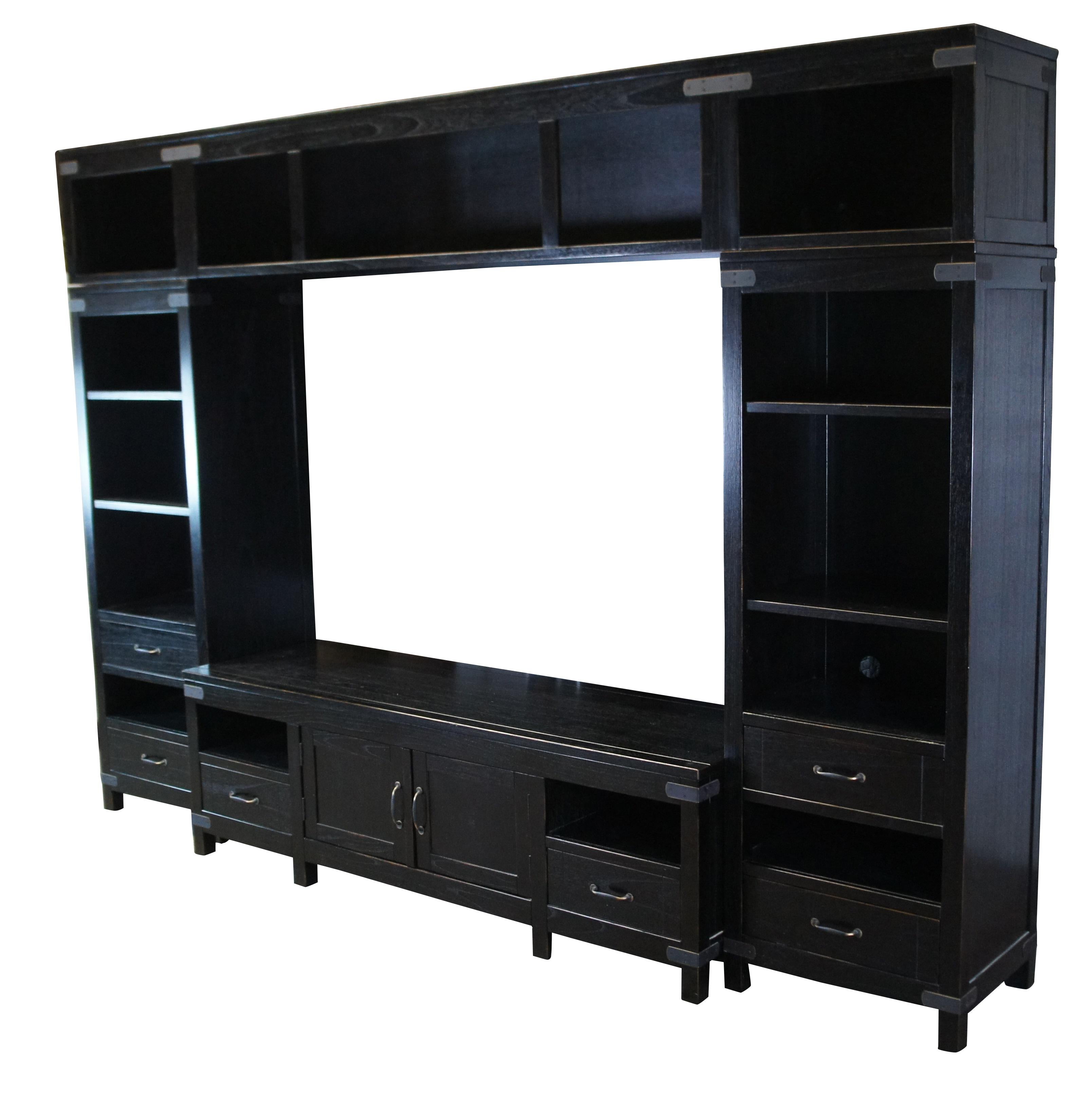 Arhaus Bentley Tremont Collection media cabinet / entertainment center / console cabinet featuring a black lacquered campaign style wall unit with multiple bookcases, shelves, drawers and a large area for a flatscreen TV.  The Tremont Collection is