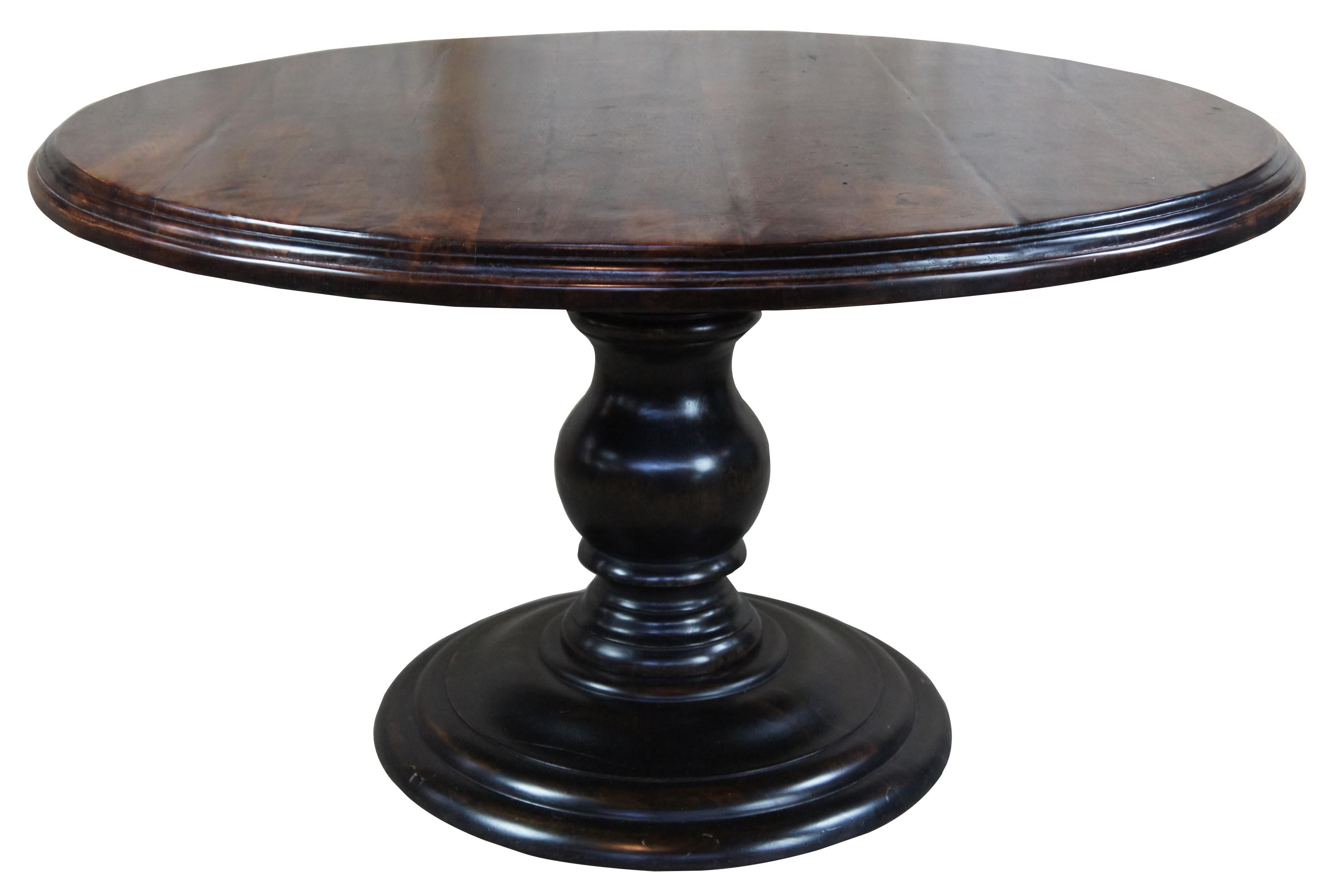 Arhaus round dining table with pedestal base. Features a plank inspired top over a turned baluster base.