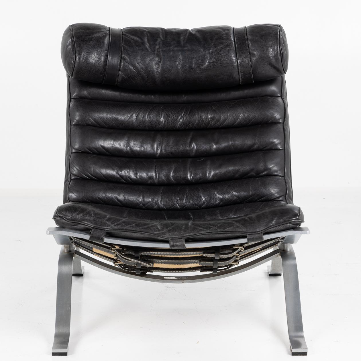 'Ari' easy chair with matching stool in black buffalo leather and steel frame.
Made from buffalo leather original. Designed by Arne Norell for Norell Möbel AB.
