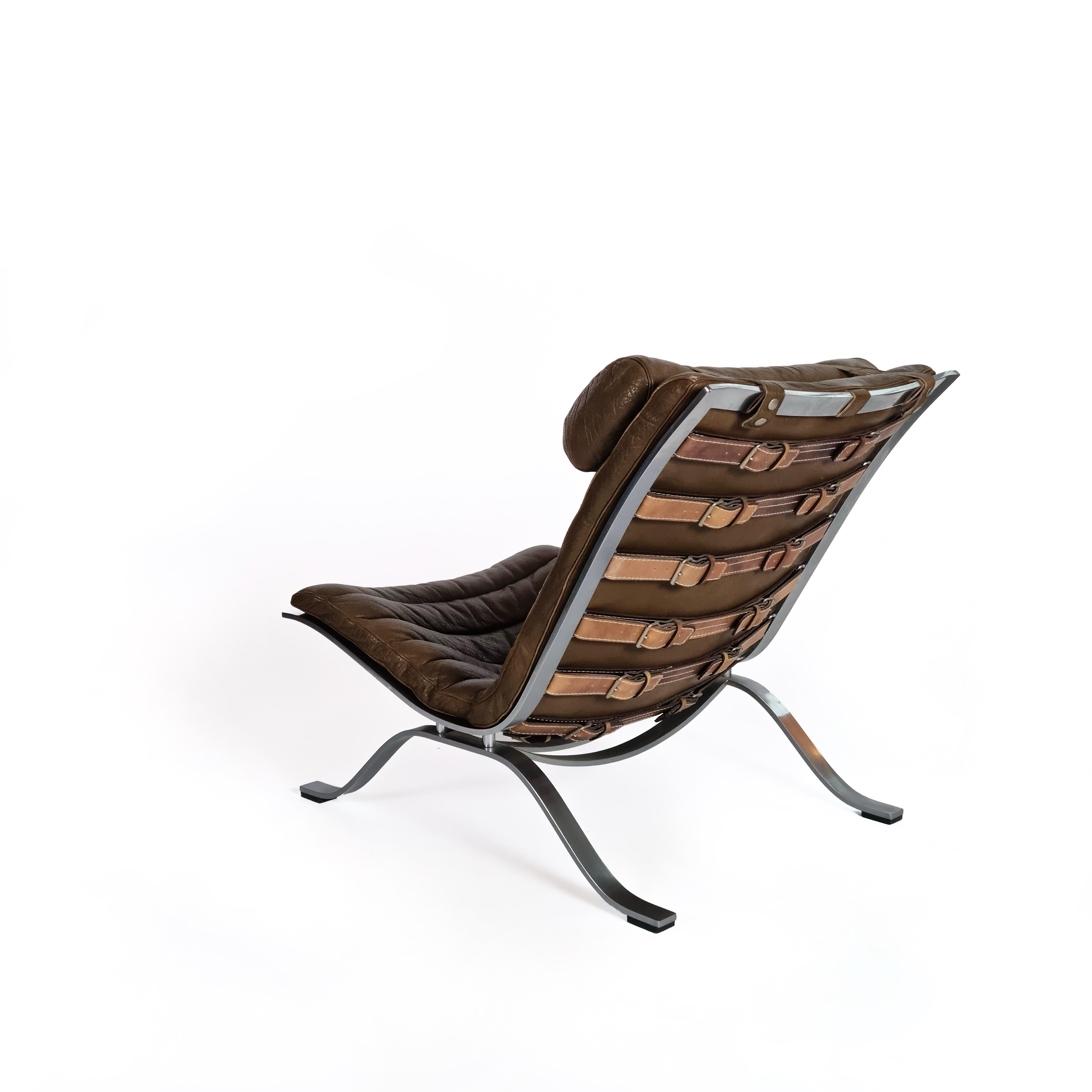 Ari lounge chair with a chrome steel frame, designed by Swedish designer Arne Norell in 1960. This vintage lounge chair & ottoman are in aniline leather. This leather is naturally tanned and dyed, giving it a distinct sheen. The chair still features