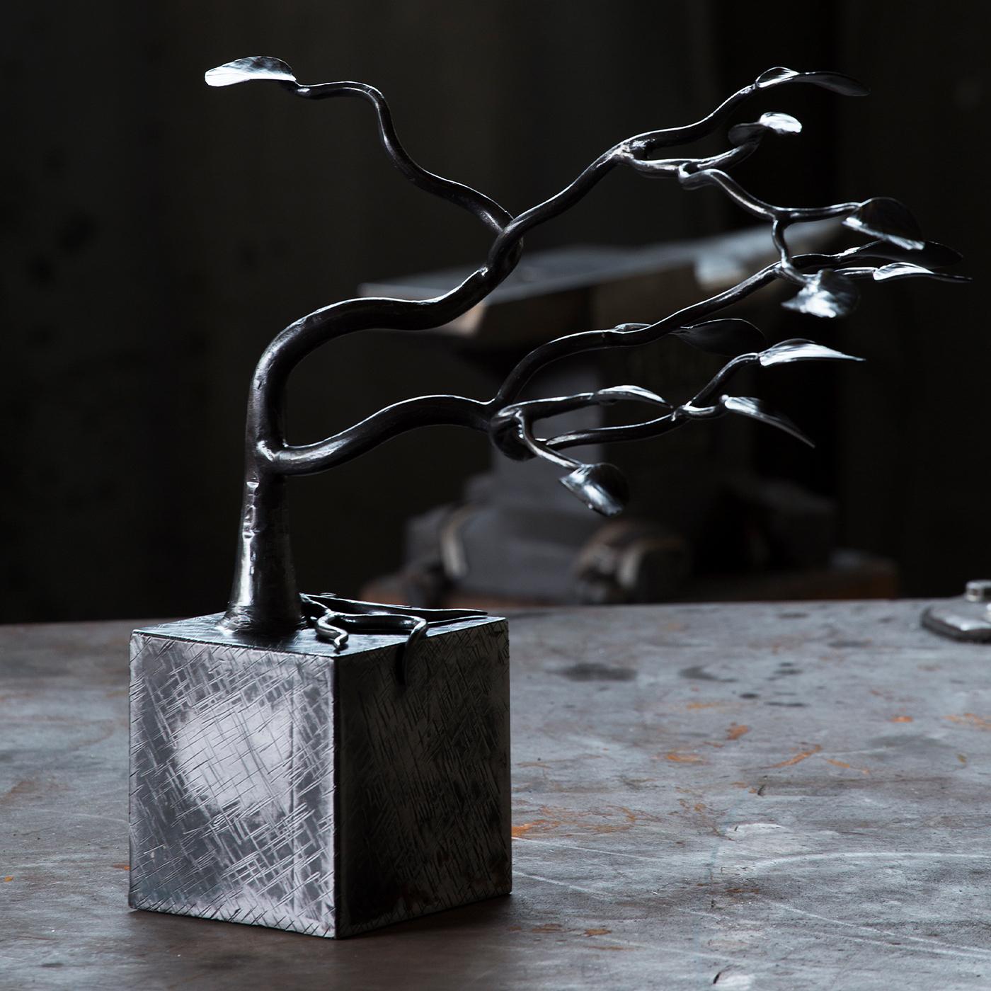 The Aria Sculpture exudes a lightweight, airy character that symbolizes the wind softly caressing branches and leaves. Sophisticated and unique, it is handcrafted of beaten iron and will timelessly adorn any style of decor. Finished with various