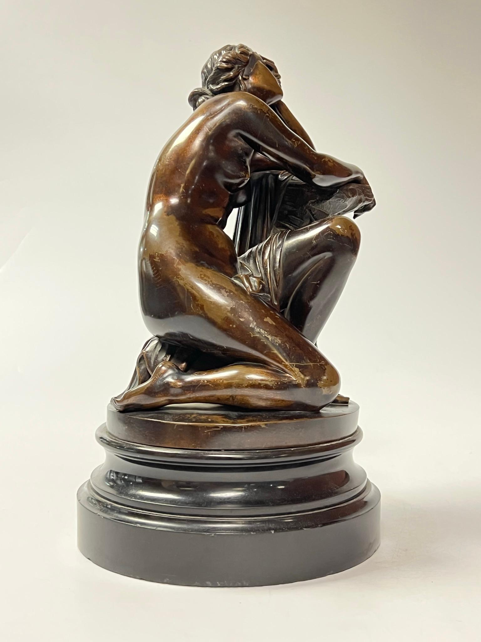 Patinated bronze figure of Ariadne after Aime Millet (French, 1819-1891), mounted on circular base of carved slate stone.  