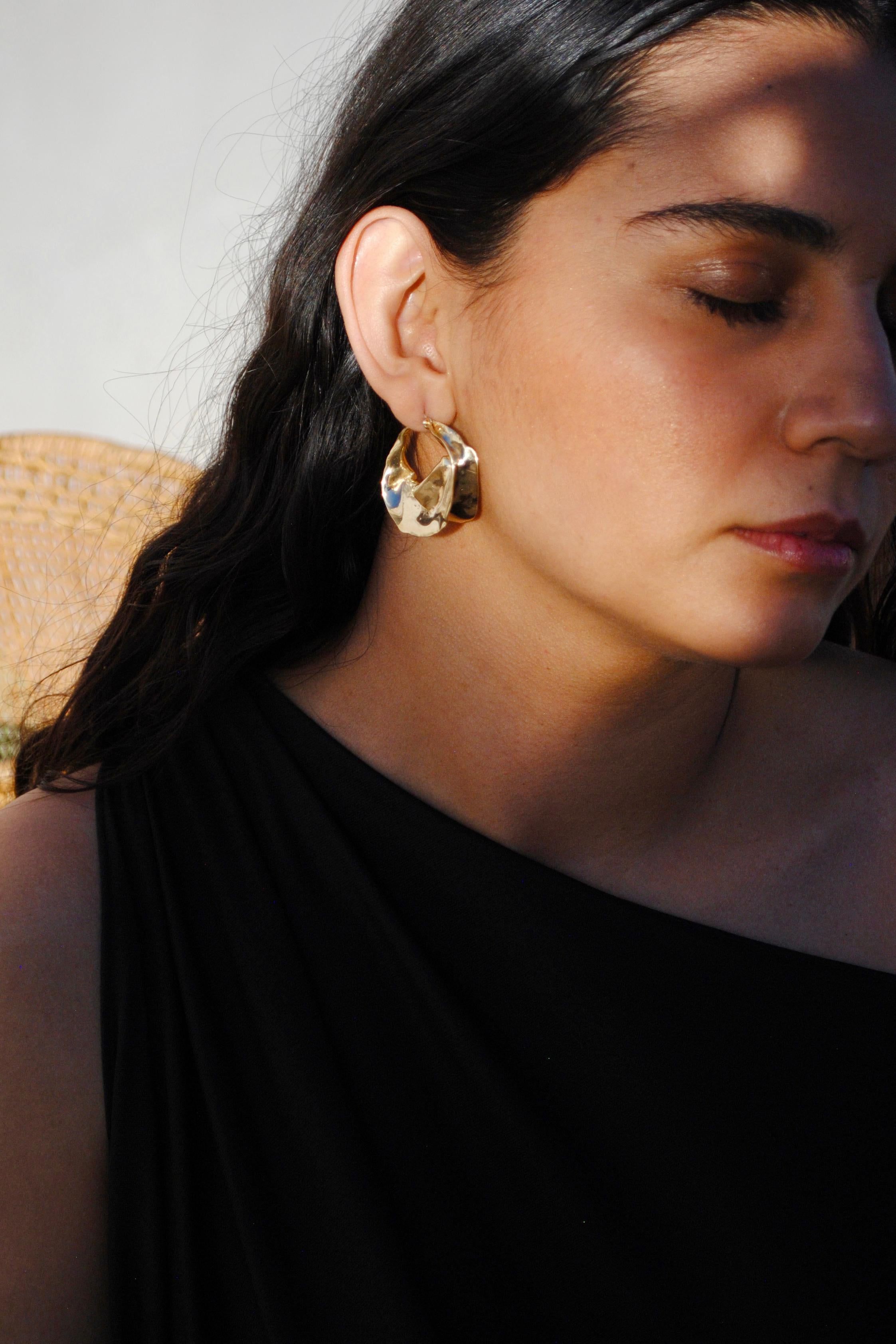 Our best-selling earring is inspired by the gold jewelry of the Fulani tribe's women of North Africa and the blooming flowers of Georgia O'Keeffe’s painting. The Georgia Earrings are an easy and elevated hoop for every day and the perfect traveling