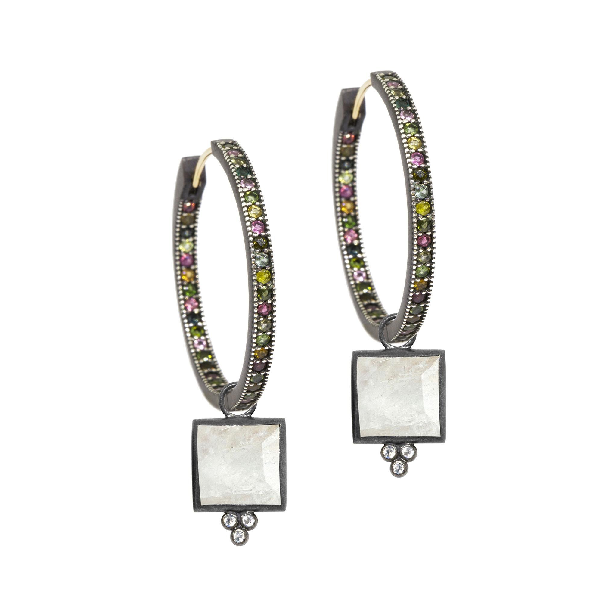 Square dance: Designed with hand-faceted moonstone framed in a textured blackened silver, our diamond-accented Ariana Oxidized Charms pair with any of our hoops and mix well with other styles.
Nina Nguyen Design's patent-pending earrings have an