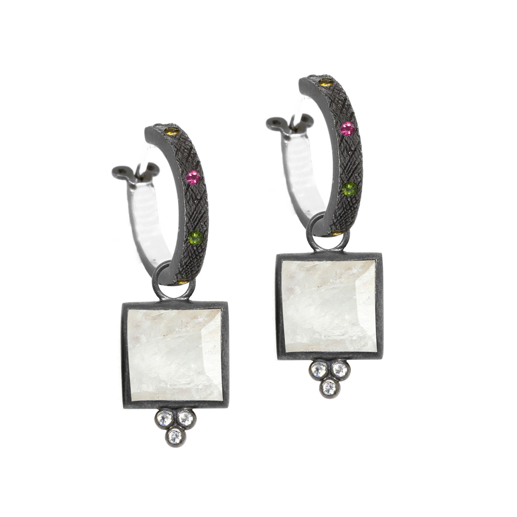 Square dance: Designed with hand-faceted moonstone framed in a textured blackened silver, our diamond-accented Ariana Oxidized Charms pair with any of our hoops and mix well with other styles.
Nina Nguyen Design's patent-pending earrings have an