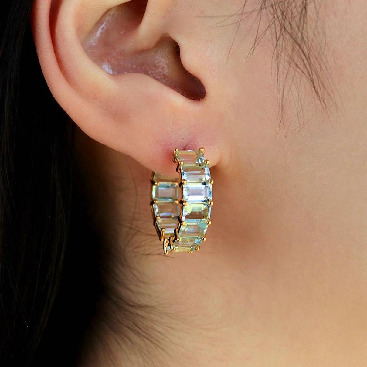 Crafted with meticulous attention to detail, these inside-out hoops are designed to hug the earlobe while showcasing a continuous line of sparkling aquamarine. The unique design provides a flattering silhouette that enhances your natural beauty,
