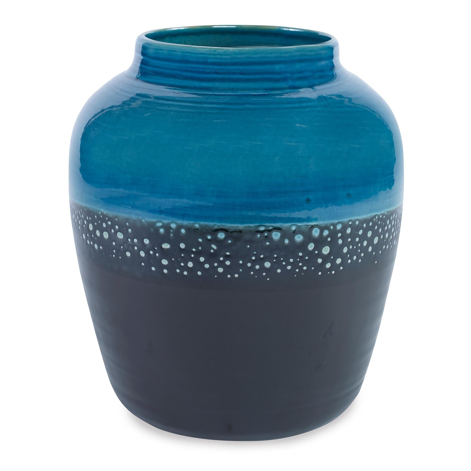 A hand painted, earthenware vase with a reactive blue and black glaze. Due to the handmade nature of this product, variation is to be expected from piece to piece.
 