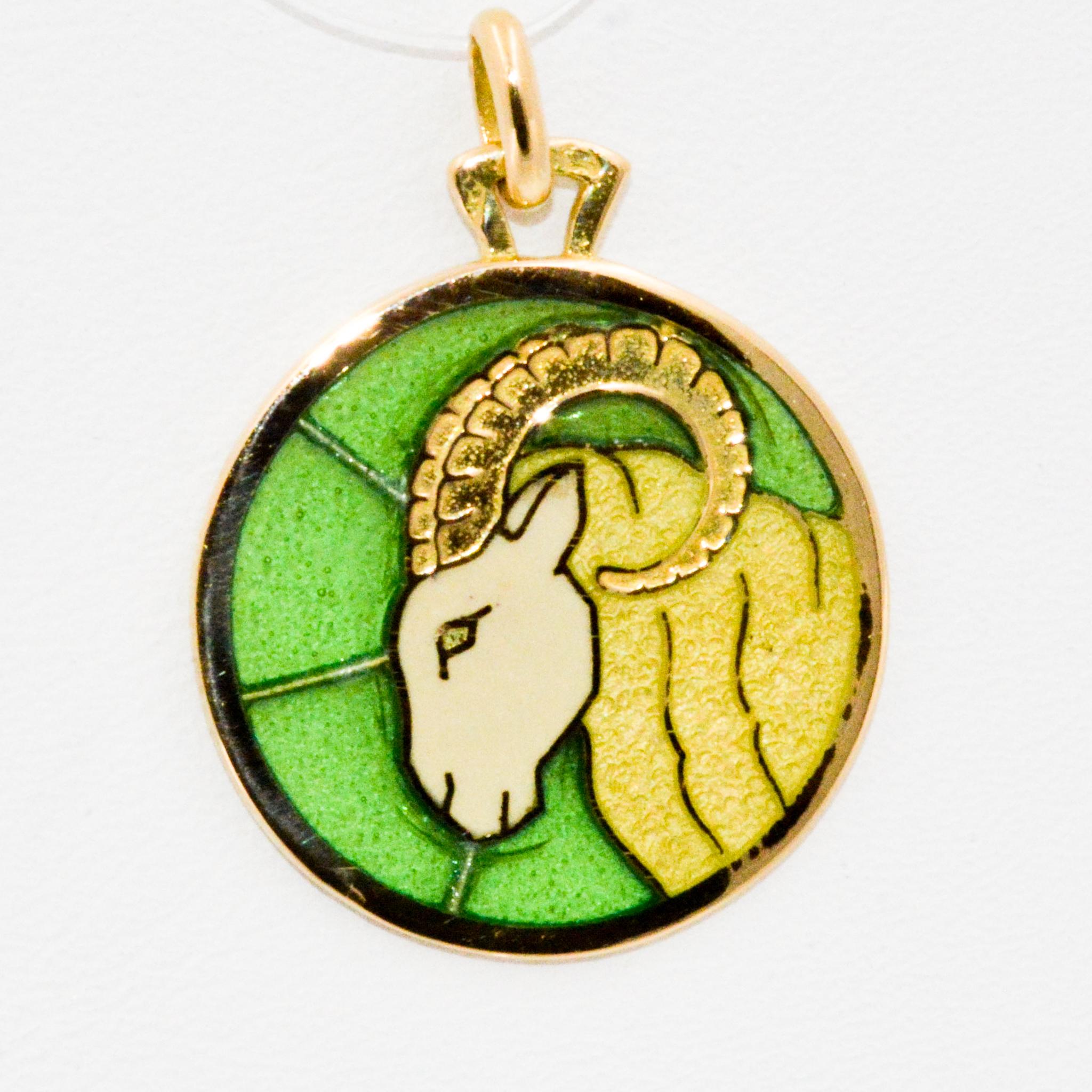 This plique a jour Aries pendant is light as a feather with intricate detailing in 18 karat yellow gold and handmade enameled glass showcasing a magnificent ram. This is the perfect gift for the Aries in your life. The pendant measures 20mm in
