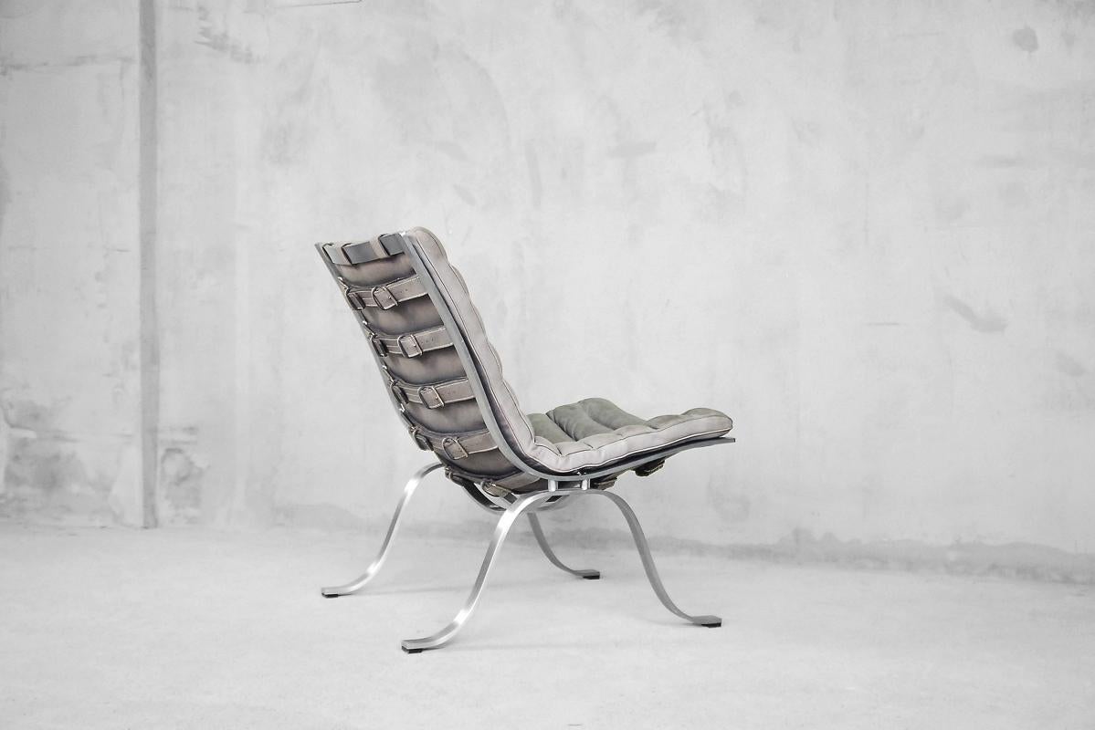 This rarely seen 'Ariet' Lounge chair was designed by Swedish Designer Arne Norell for Norell Möbel AB in 1966. It is made from beautiful grey patinated buffalo leather and finest matte chromed frame. Please note the beautiful belts with buckles,