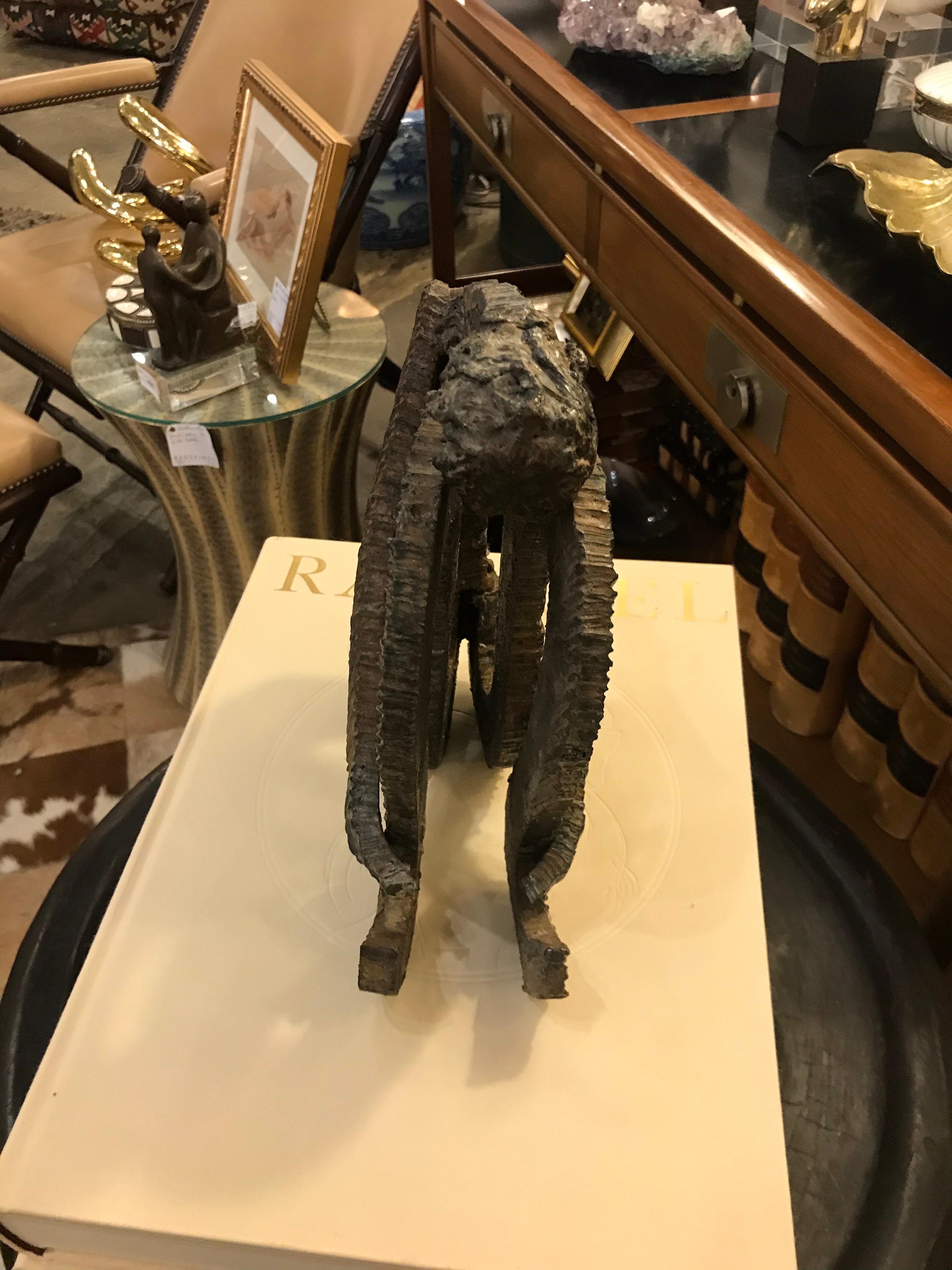 This is an iron corrugated textured abstract figure by the sculptor Arik Amir born in Tel Aviv in 1922 As an artist he started his own Artist colony where he sculpted with many other artists in the city of Safed.