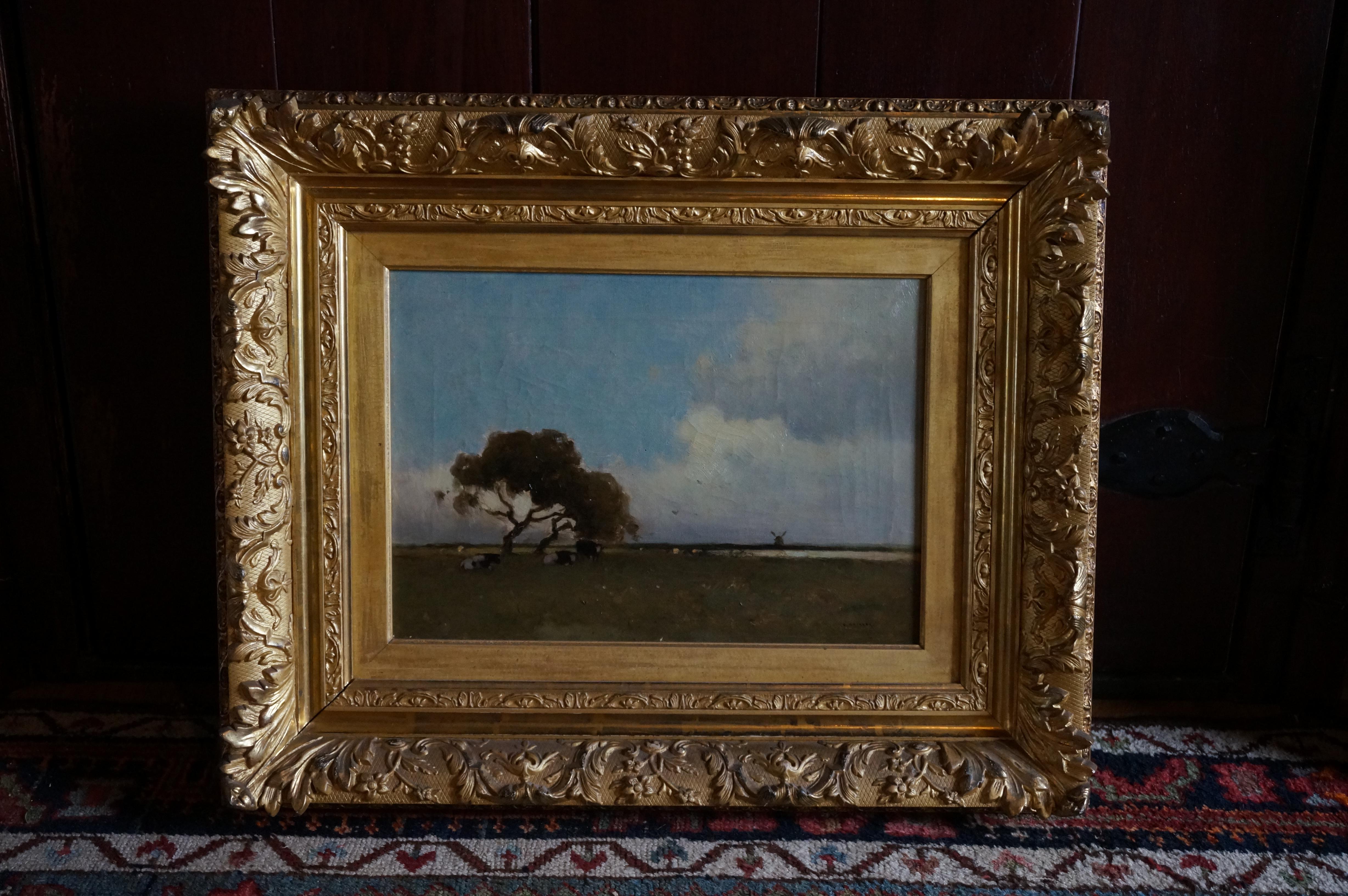 Dutch landscape with cows resting underneath a tree and windmill on the horizon For Sale 8