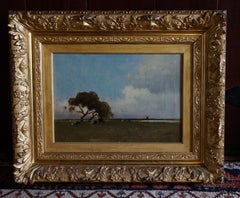 Dutch landscape with cows resting underneath a tree and windmill on the horizon