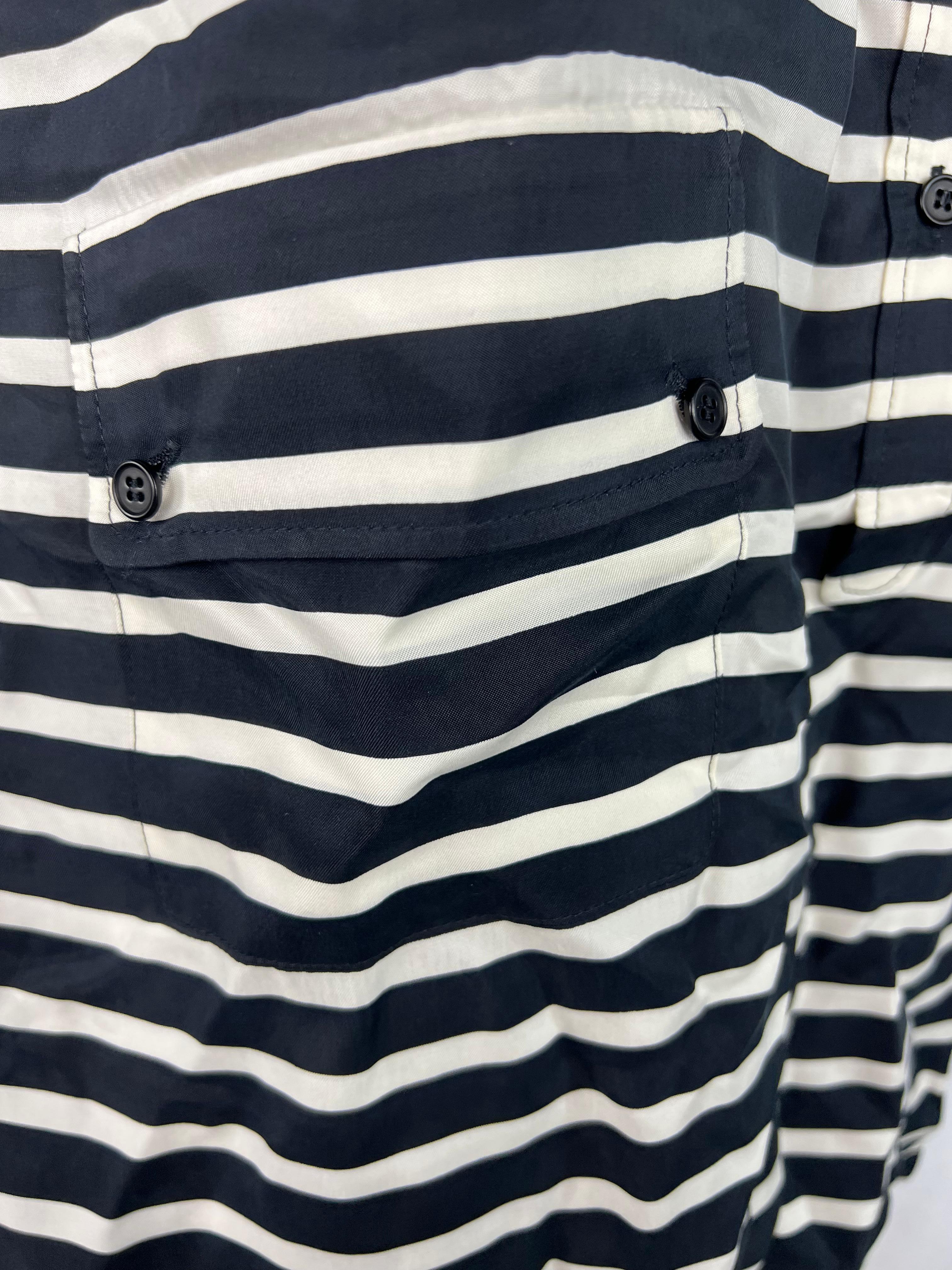 Product details:

The shirt features navy and white striped pattern with front half button closure, front dual pockets detail.