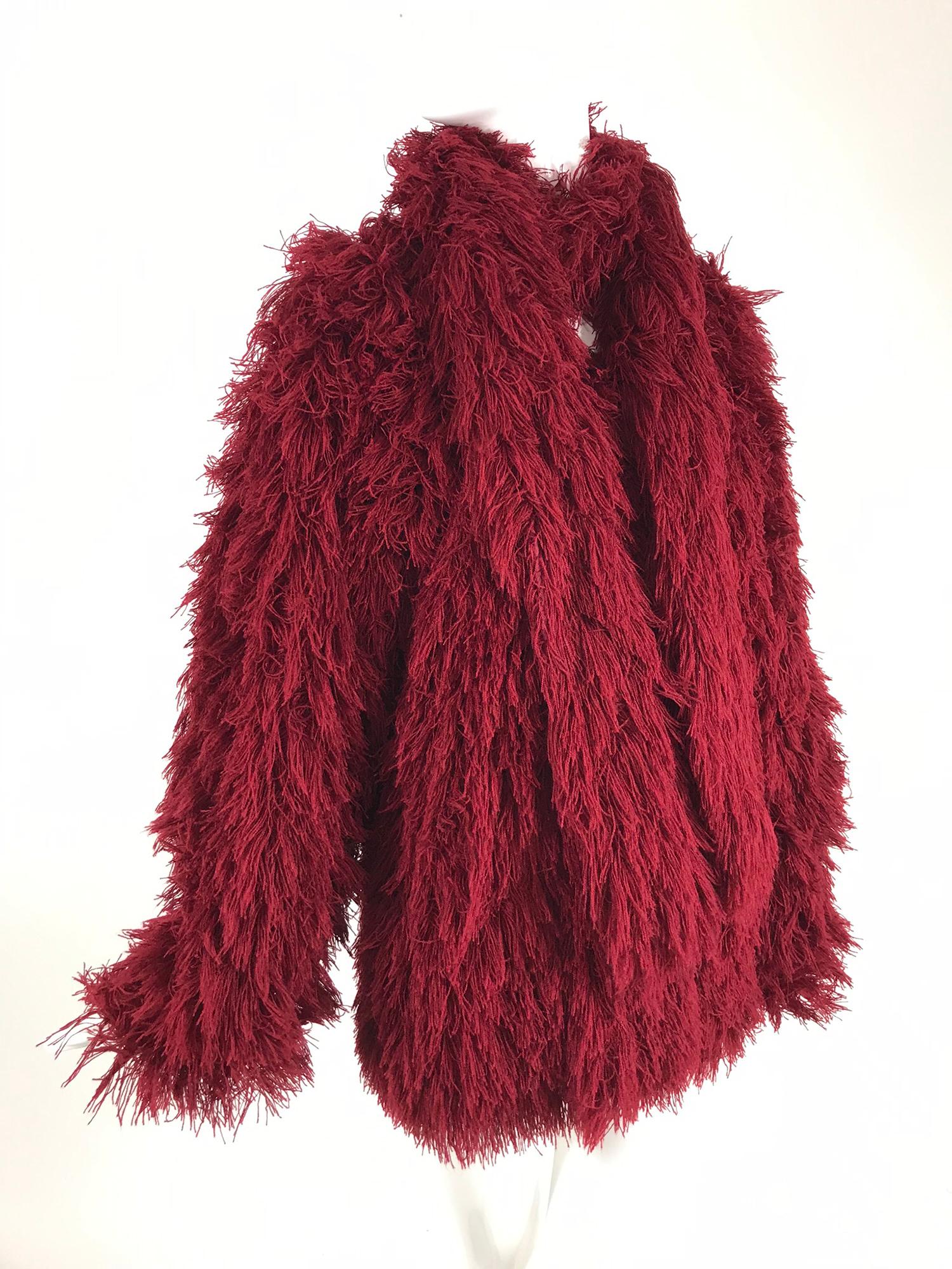 Arissa France burgundy faux fur jacket and scarf from the 1980s. This faux fur jacket has the look of Mongolian lamb. Long sleeve jacket with a V neckline, angled front pockets and matching long scarf. The fabric is similar to wool string, it looks