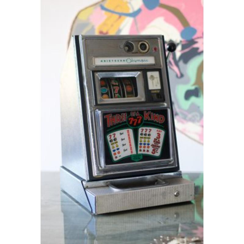 Aristocratic Olympic Three of a Kind Slot Machine, London, United Kingdom, 1960s
 
 Vintage Design
 Immerse yourself in the excitement of the game with our slot machine! Its captivating design and sparkling lights instantly transport you to the