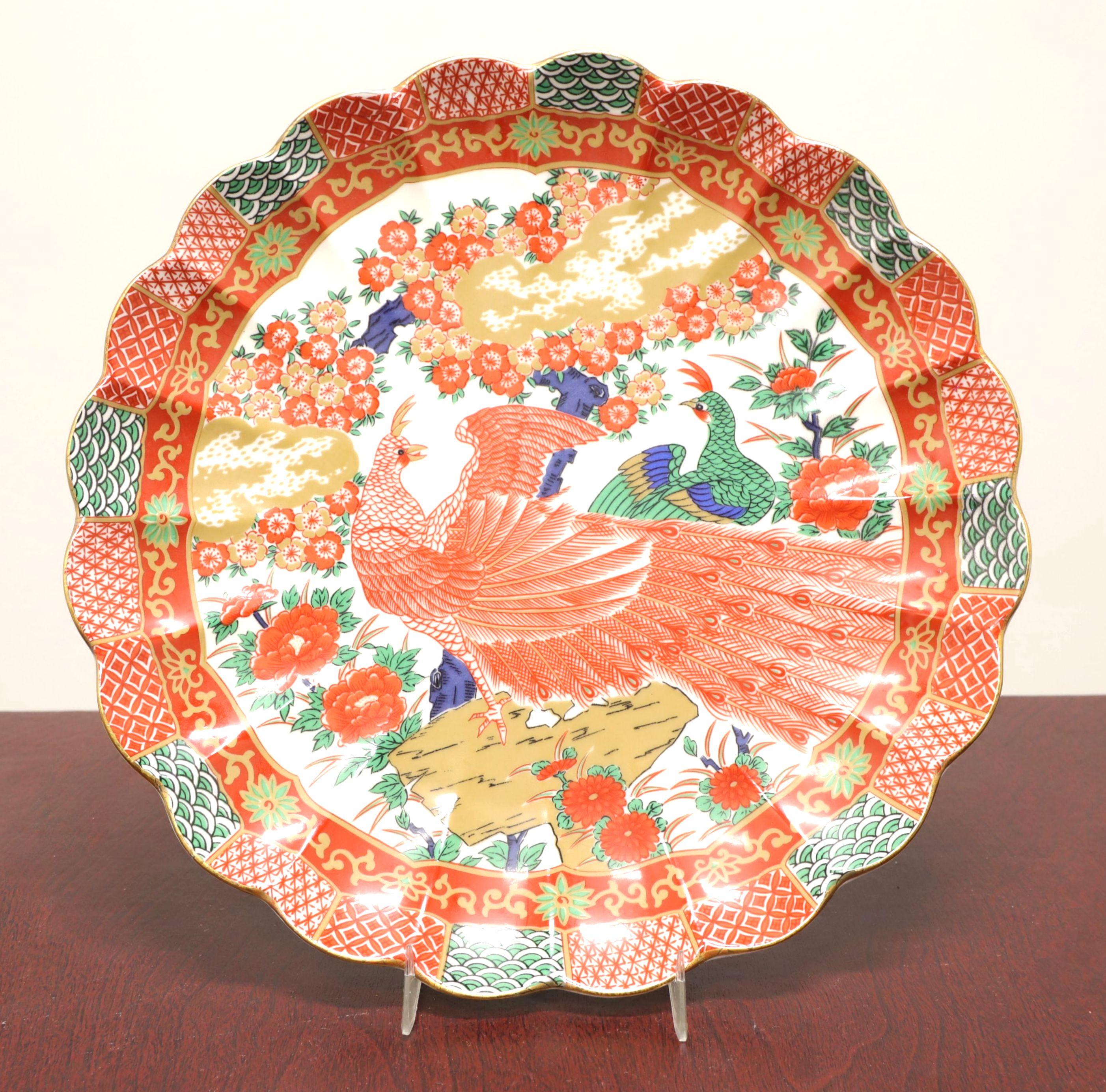A set of Mid 20th Century Asian style serving pieces by Arita Fine China. Fine reproduction Imari ware porcelain; hand painted in orange, white, green, blue & gold colors of a peacocks design, consisting of two pieces: Chop Plate and Vegetable Bowl.
