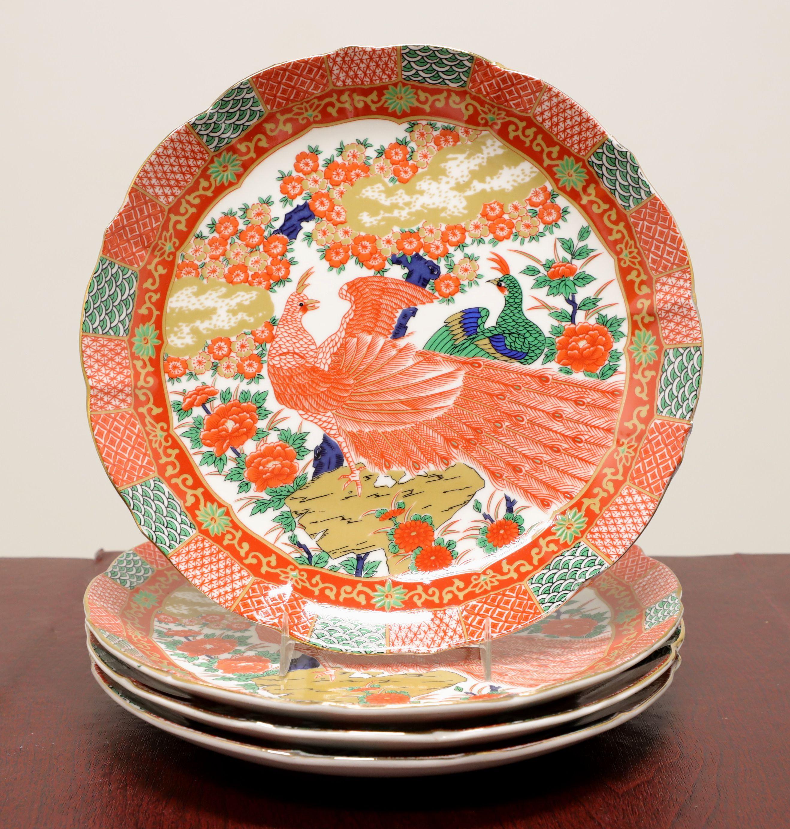 A Mid 20th Century Asian style dinner service for four by Arita Fine China. Fine reproduction Imari ware porcelain; hand painted in orange, white, green, blue & gold colors of a peacocks design, consisting of twenty-one pieces: four Dinner Plates,