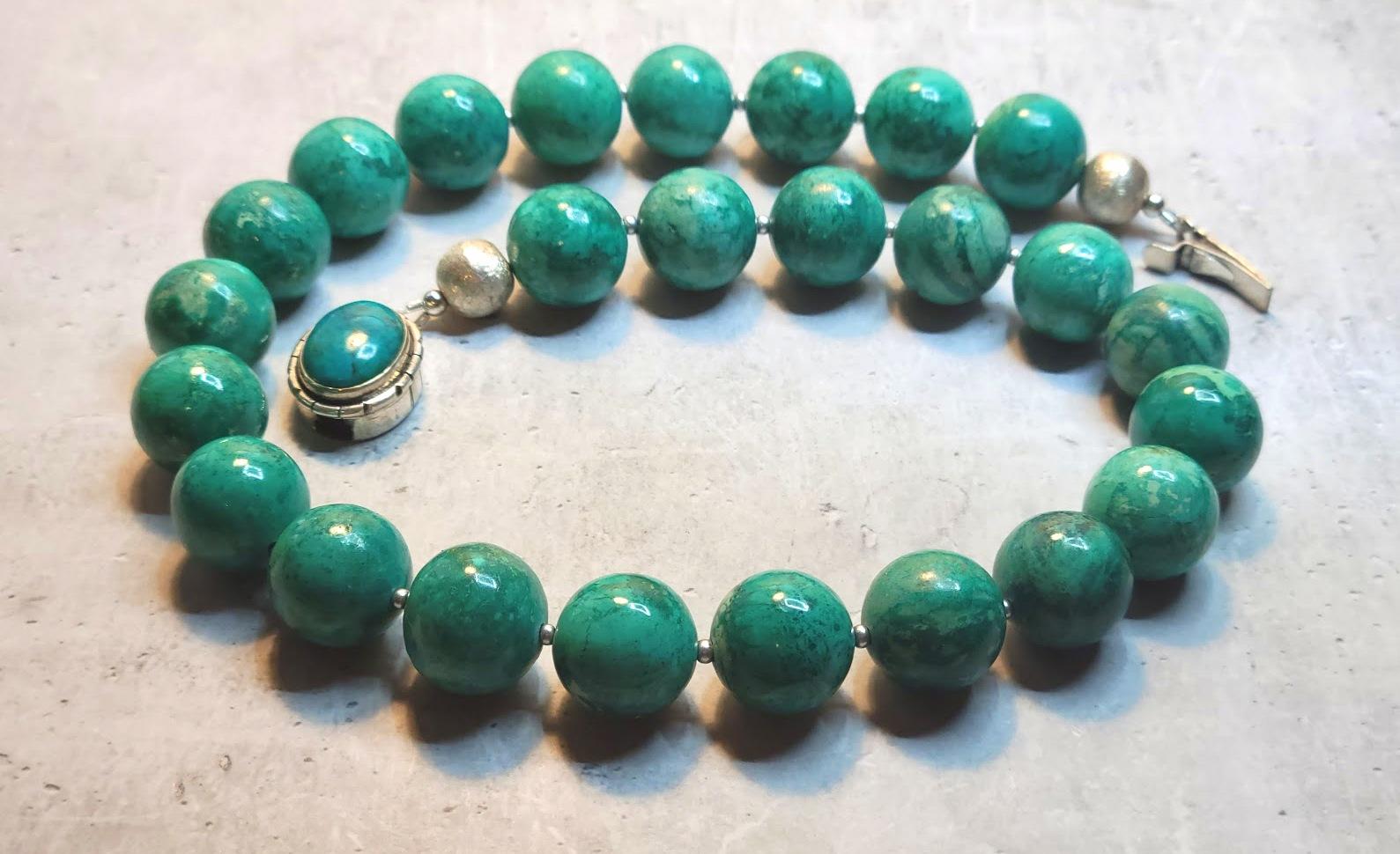 The length of the necklace is 18 inches (45.7 cm). The size of the smooth round beads is 16 mm.
The beads' color is bright and deep. They are a mixture of sea green and aquamarine with an admixture of green, light blue, celadon, and sky