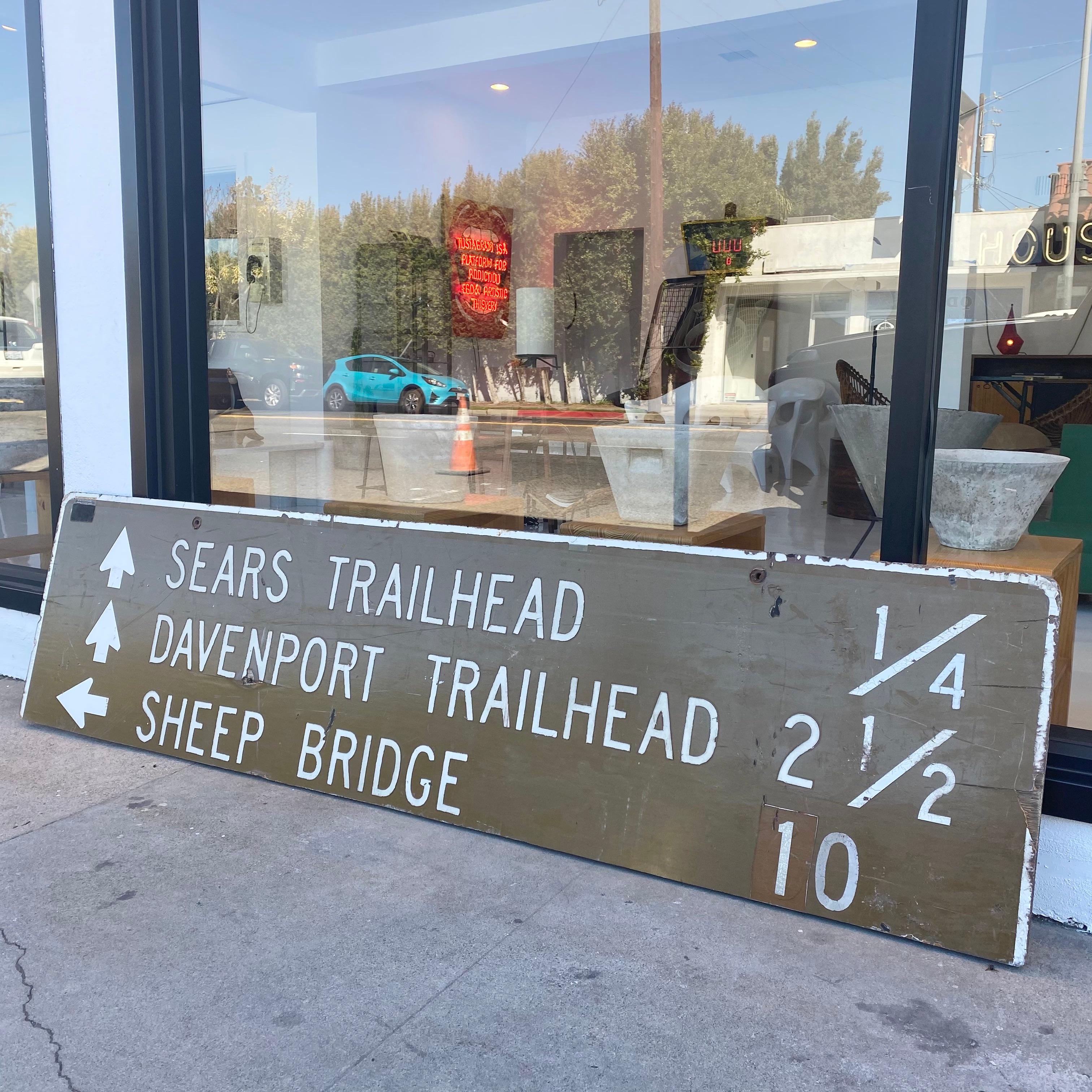 Unique vintage trailhead sign. 6.5 feet long and 1.5 feet tall. Wooden sign from Davenport/ Sears Loop Trail in Horseshoe dam, Arizona, a remote section of the Mazatzal's that sees little use. Sign indicates with arrows 