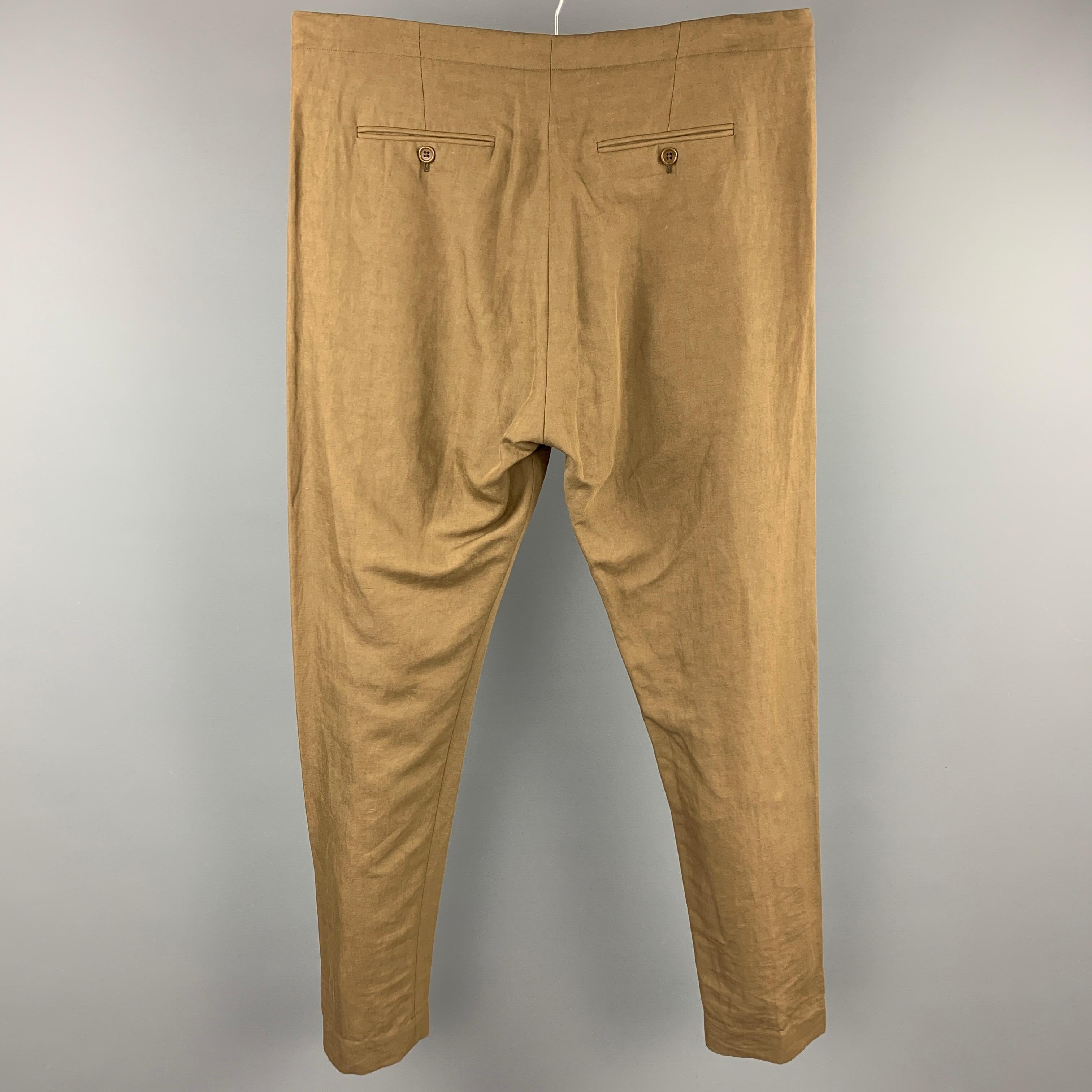 ARJE dress pants comes in a olive cotton / linen featuring a slim fit, slit pockets, and a button fly closure. Made in Italy.

New With Tags. 
Marked: L
Original Retail Price: $320.00

Measurements:

Waist: 36 in.
Rise: 13 in.
Inseam: 31 in. 