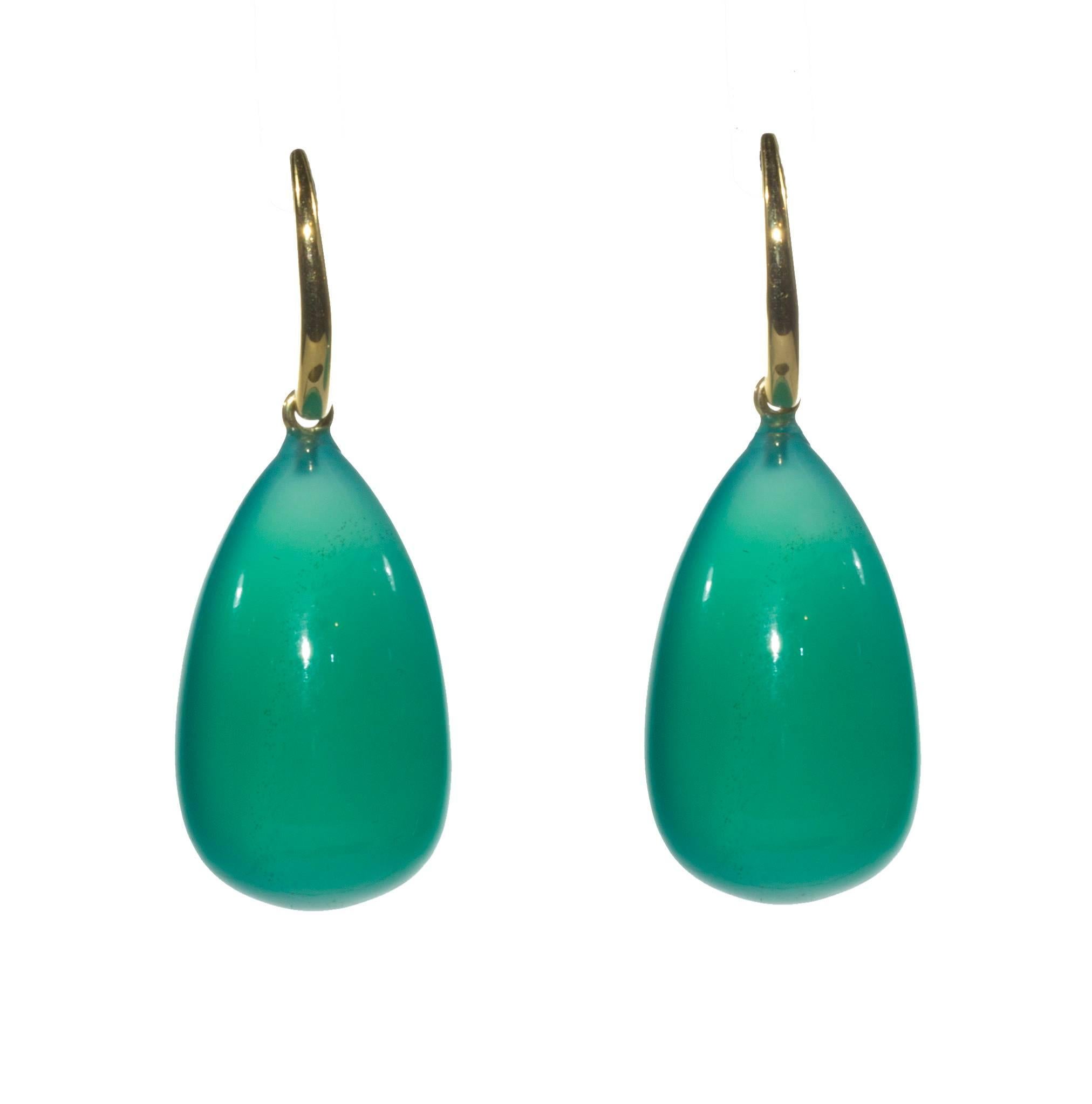 Translucent green agate and 18K gold drop earrings. Cut as a smooth briolette, due to the perfection of the stone (no veins or inclusions of any kind) they become pools of light next to the face of the wearer. The stones are perfectly balanced on