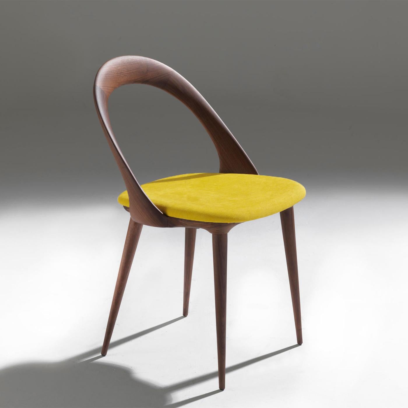 Chair Ark Walnut with structure in solid walnut wood,
seat upholstered and covered with high quallity velvet 
fabric (Cat. C) in yellow color.
Also available with other fabrics, on request.