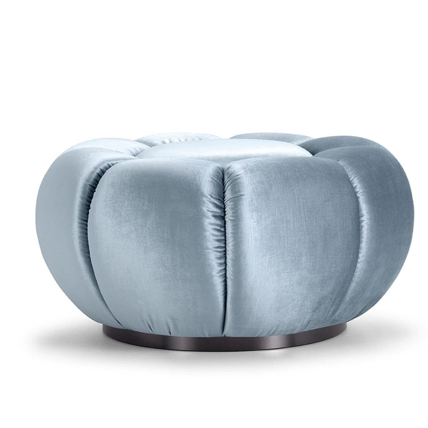 Recalling the appearance of flower buds, this handcrafted, circular pouf belongs to a sophisticated collection inspired by Arke, Greek mythological goddess and messenger of the Titans. The channeled texure given to the seat adds character to the