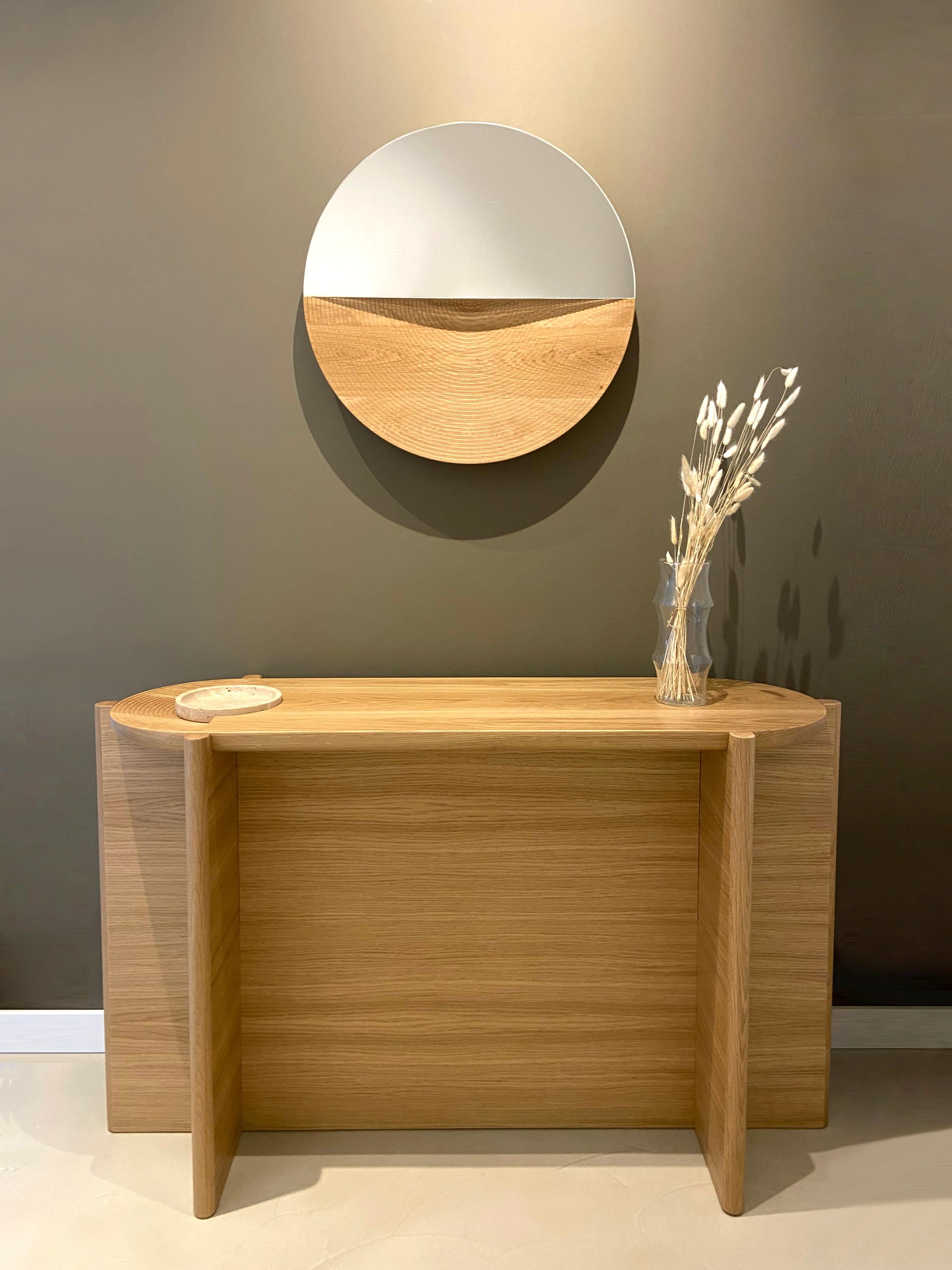 Arkhe console table is a graceful combination of functionality, simplicity and sculptural posture. The natural beauty of oak and travertine, exquisite craftsmanship and the inspiration coming from stunning amphitheaters of old times gives this