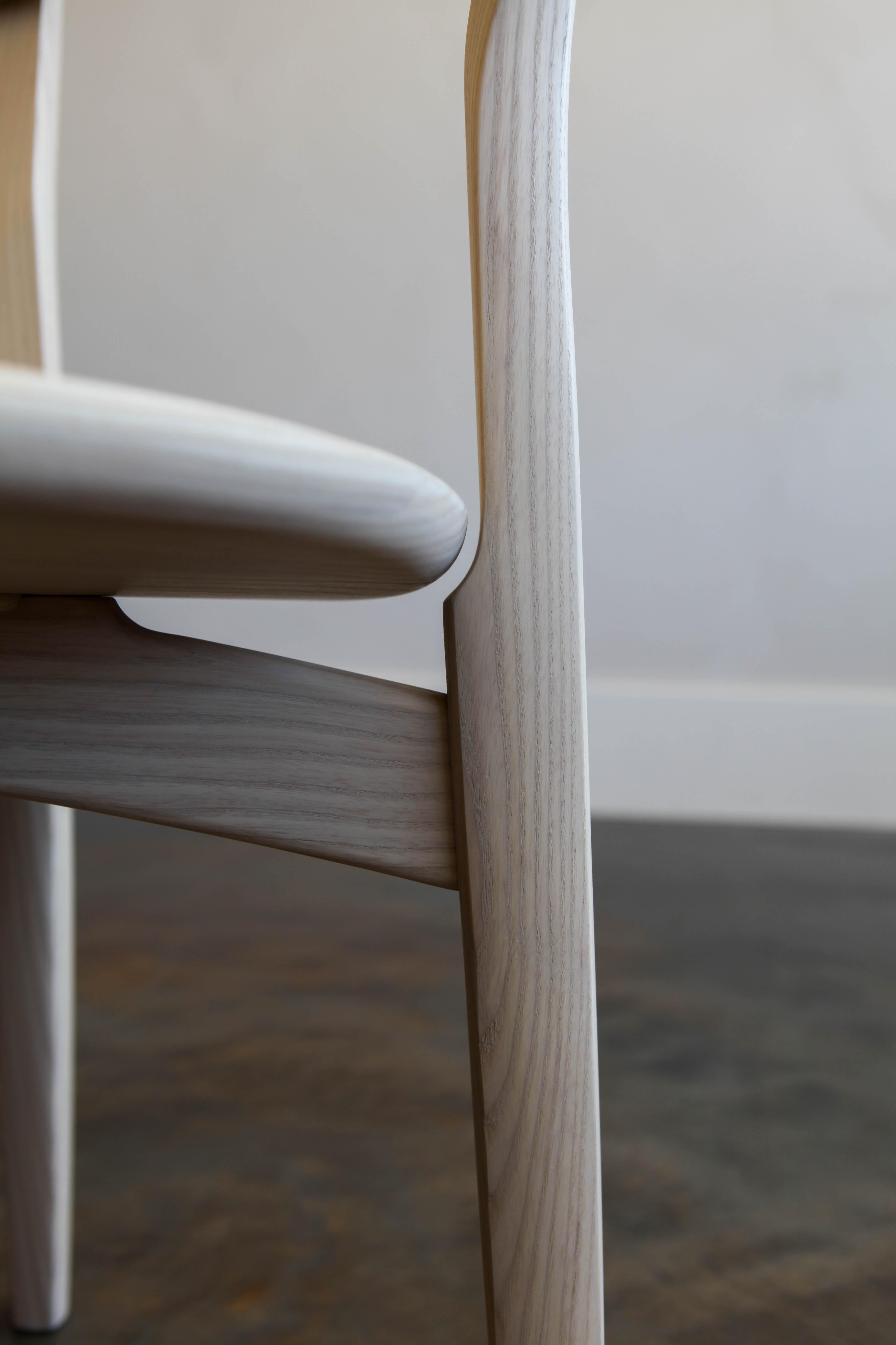 Arla Dining Chair - Where structure meets softness, the Arla Chair plays with balance in all the right ways. Inspired by Scandinavian minimalism, it pairs clean architectural lines with unexpected, playful curves — creating a silhouette that feels