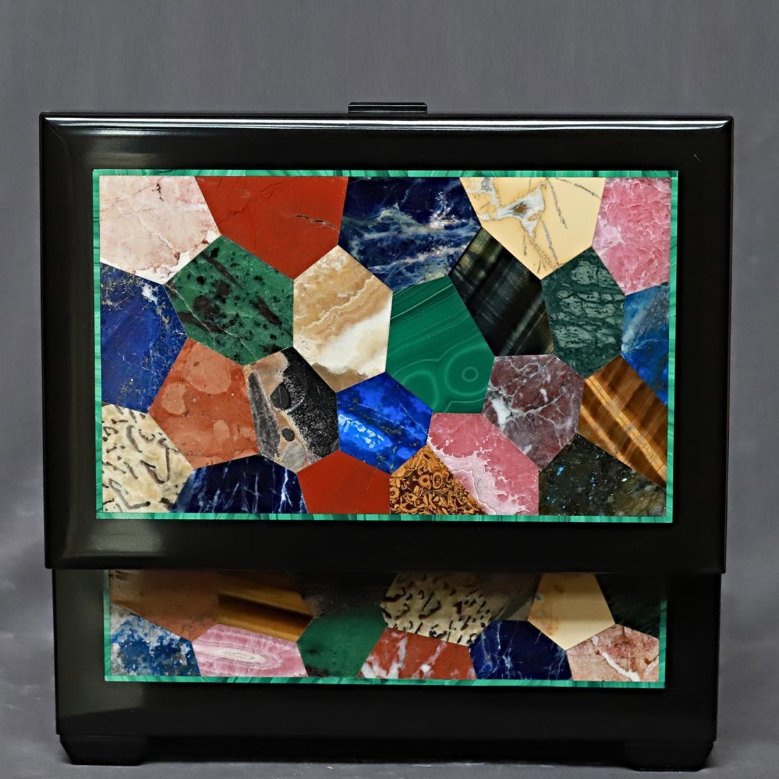 Precious memories impressed on polaroids or jewelry favorites will be luxuriously treasured within this rectangular-cut box. Black Belgio marble is featured to craft its general structure - feet included - while rhodochrosite, tiger eye, lapis