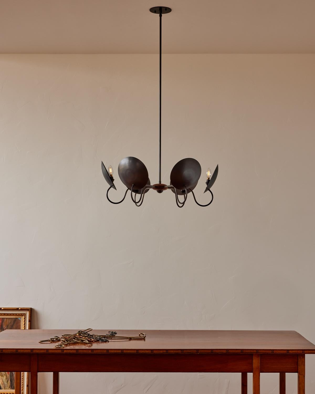 The Arlo Chandelier is centered by a walnut cluster. Each curved brass arm extends outward to support a bench-made hand-spun bronze reflector.

OVERALL DIMENSIONS
32