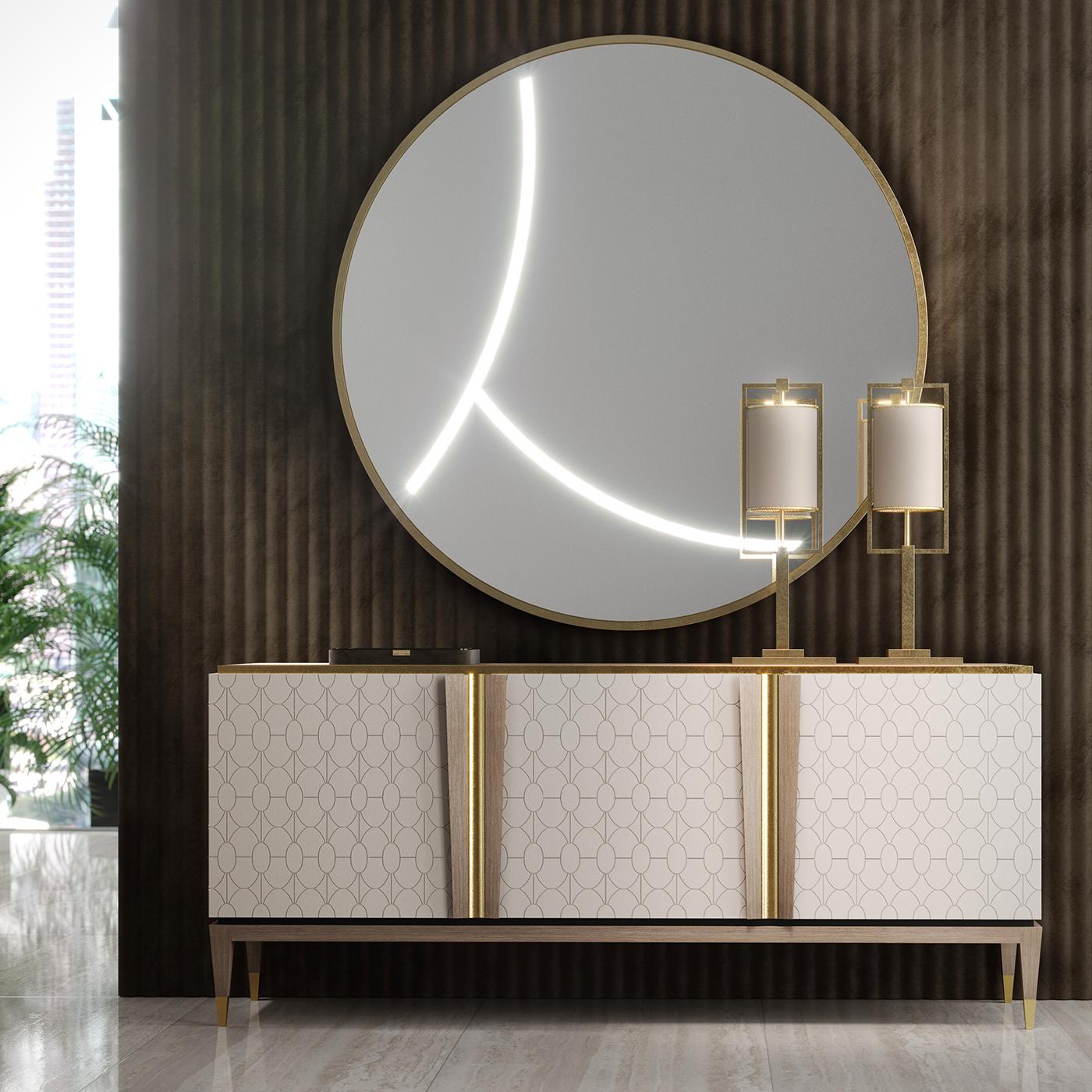The Minimalist profile of this elegant round mirror is part of the Mascari Collection, distinctive for its linear silhouettes and precious finishes. The frame boasts an MDF California Air Resources Board (CARB) frame with a metallic gold finish. The