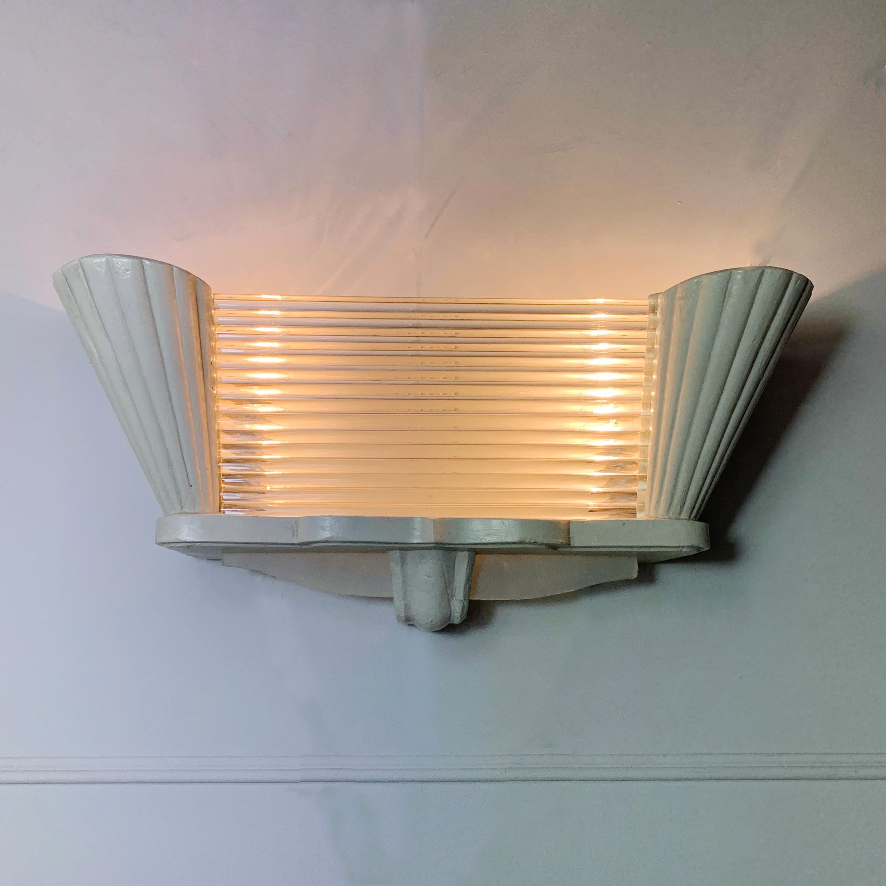 1940s Art Deco wall light from the French Design House Arlus
Individual glass rods sit within the plasterwork body lit from behind by two light fittings
While handcut glass deco fans adorn the bottom of the light
Stamped Arlus decal clearly