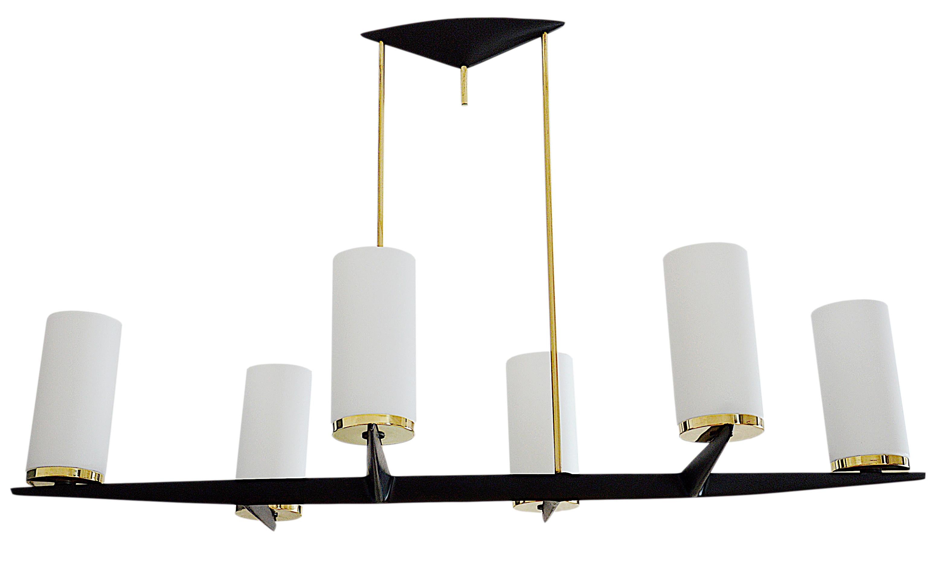 French midcentury chandelier by Arlus (Paris), France, 1950s. 6 white glass shades. Brass and painted black metal. Can be combined with wall lights that we have of the same model. Measures: Height 23.2