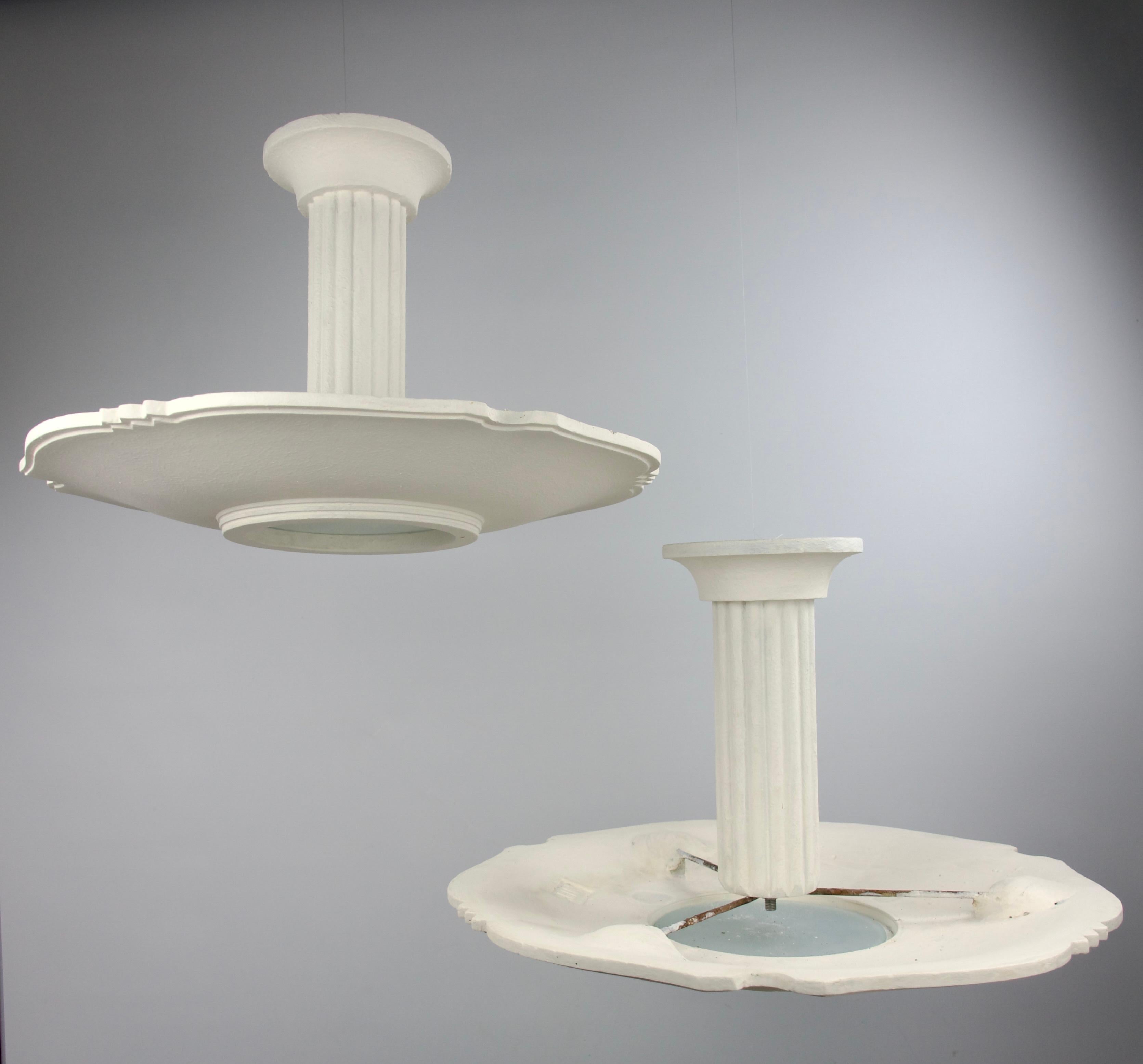 Set of two superb plaster and iron frame mid-century modern chandeliers by Arlus, France 1950s. Decorations of columns and alternations of flowing and jagged edges. Stamped by the manufacture.

Good condition. 


