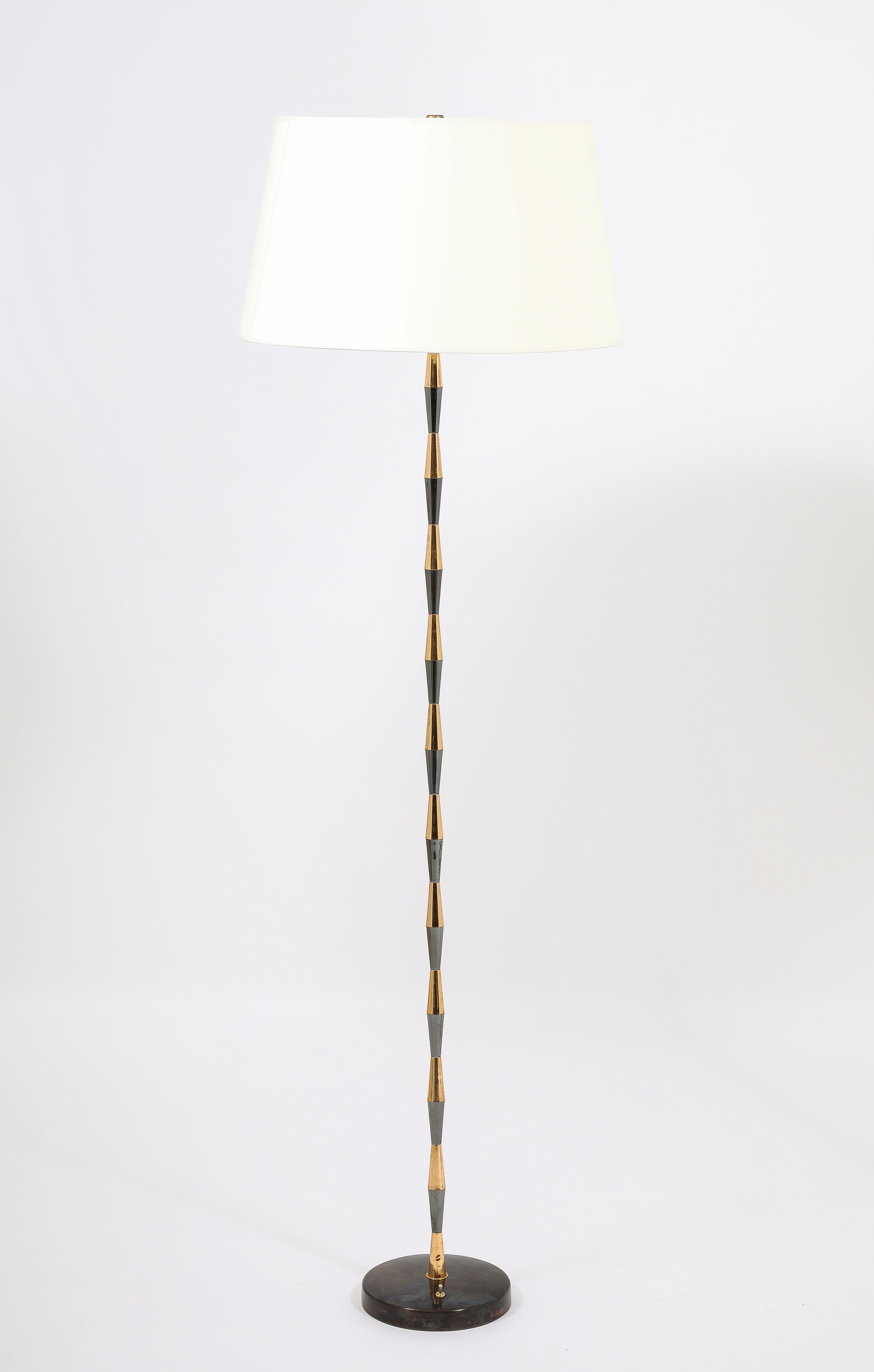Elegant gold and gunmetal floor lamps on cast bronze bases.