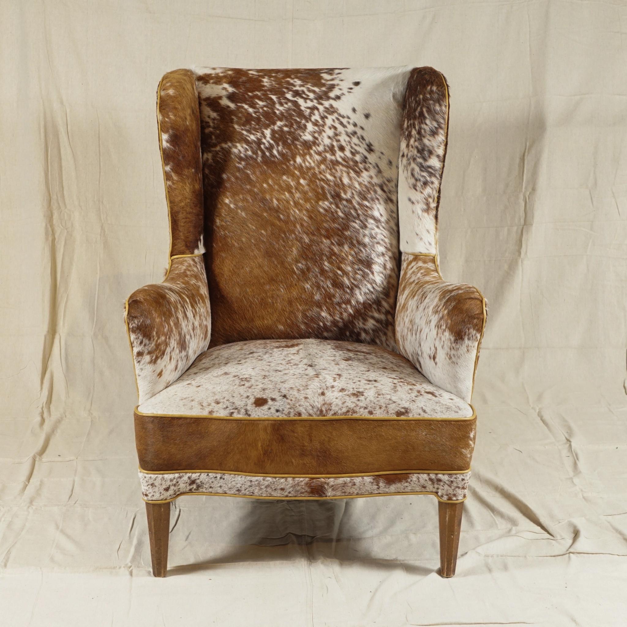 A wingback armchair by Danish designer Frits Henningsen, recovered in soft cowhide, extremely
comfortable. A pair available.

Frits Henningsen (1889-1965) was a Danish furniture designer and cabinet maker who achieved high standards of quality