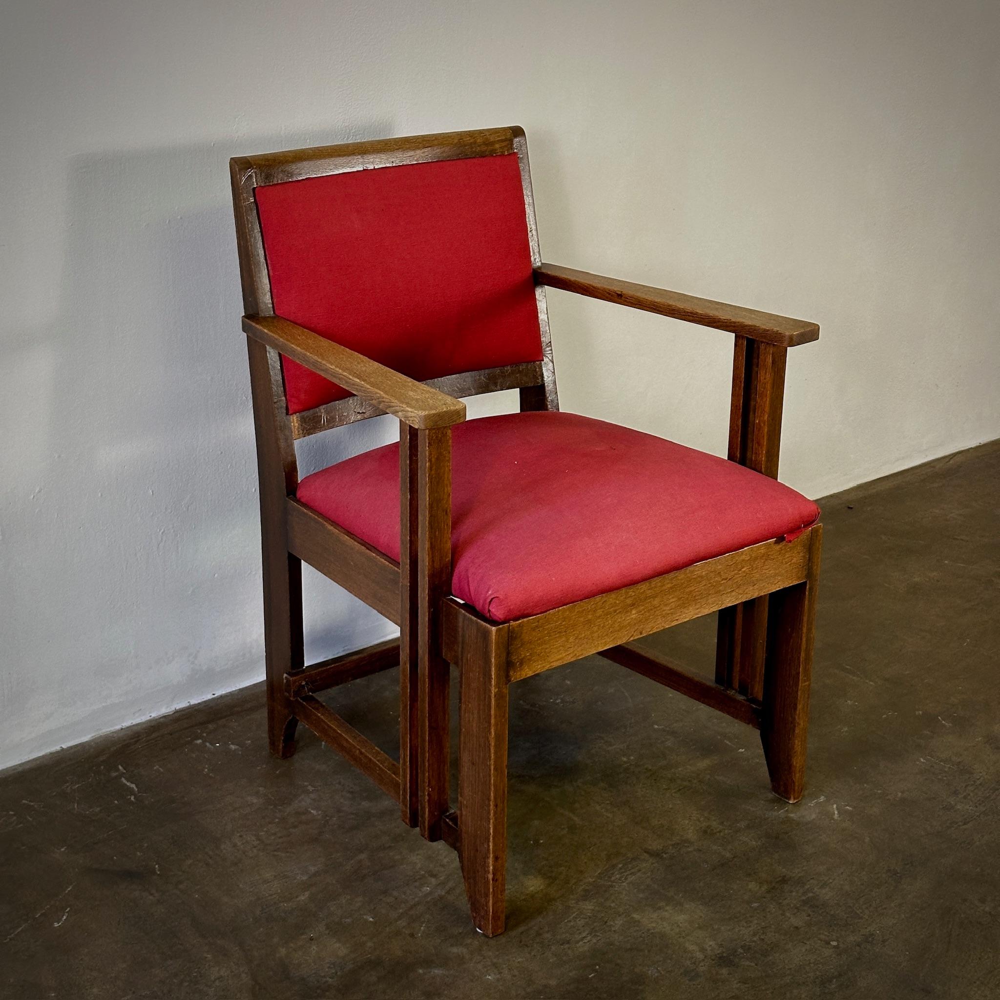 Carmine red upholstered Amsterdam School armchair with oak framework, designed by Hendrik Wouda. An exceptional work of 1930s Dutch modernism, this sleek yet inviting accent chair could work well in a variety of spaces.

Netherlands, circa