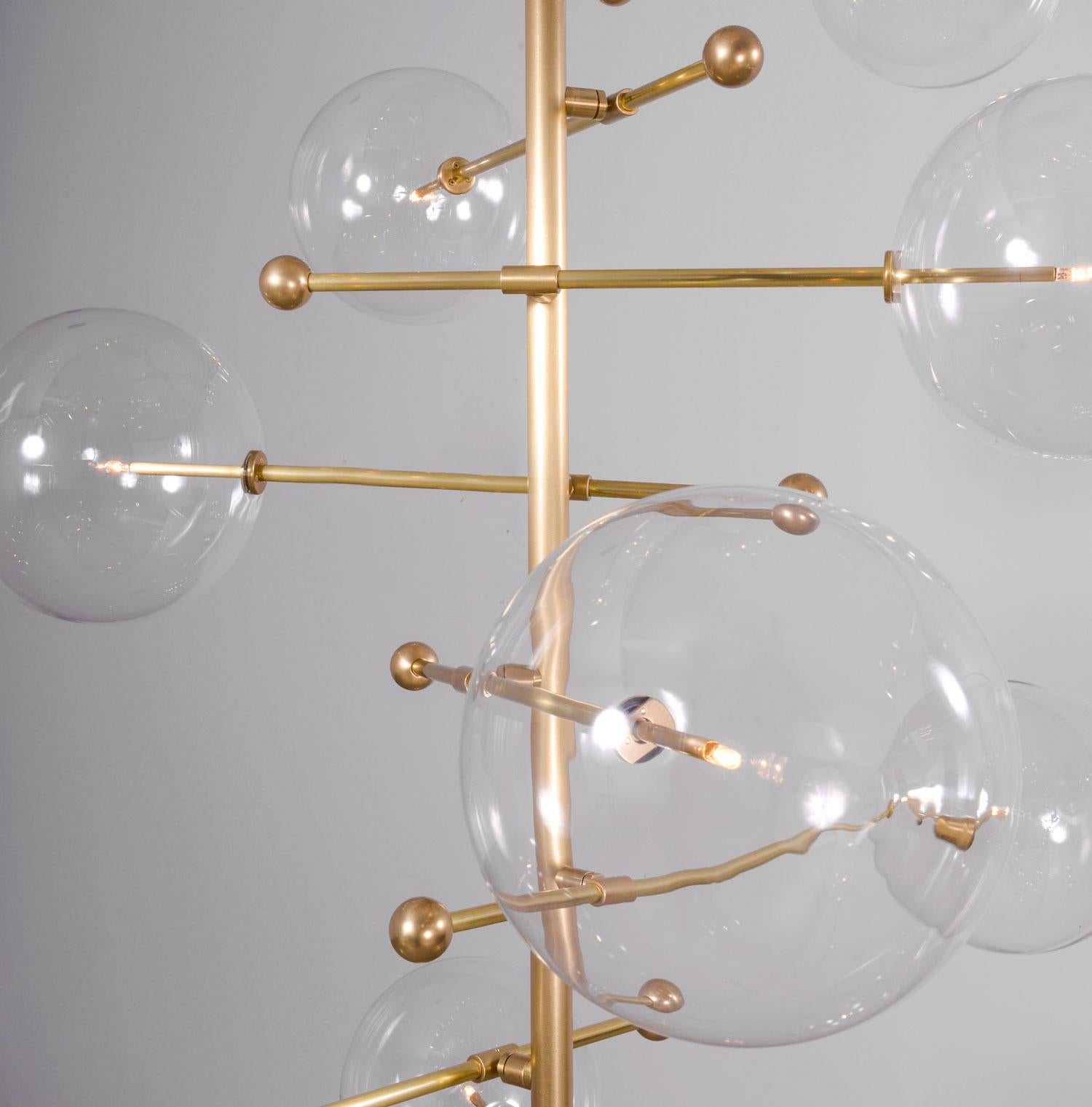 RD15 12 Arms Chandelier by Schwung
Dimensions: W 140 x D 140 x H 290
Materials: Solid Brass, Hand Blown Glass Globes
 
Schwung is a german word, and loosely defined, means energy or momentumm of a positive manner. synonyms: verve, zest, panache,