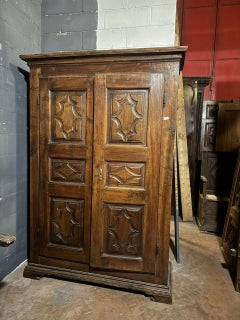 Two-door solid walnut closet, carved in panels, italy