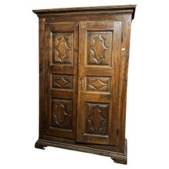 Two-door solid walnut closet, carved in panels, italy