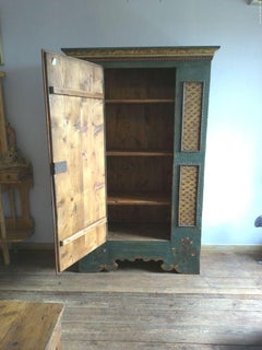 Spruce cabinet with floral painted relief frames
