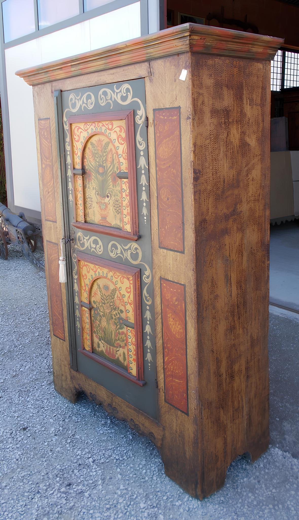 Kleines Schränkchen aus Tannenholz, mit fein gemalter Relieftür.

Originalscharniere aus der Zeit, Schloss ersetzt.
Sie stammt aus der zweiten Hälfte des 18. Jahrhunderts und hat ihren Ursprung im Tiroler Alpenraum.
Sie ist in einem guten