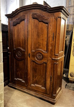 A two-door poplar wood cabinet, 18th century. Italy origin.