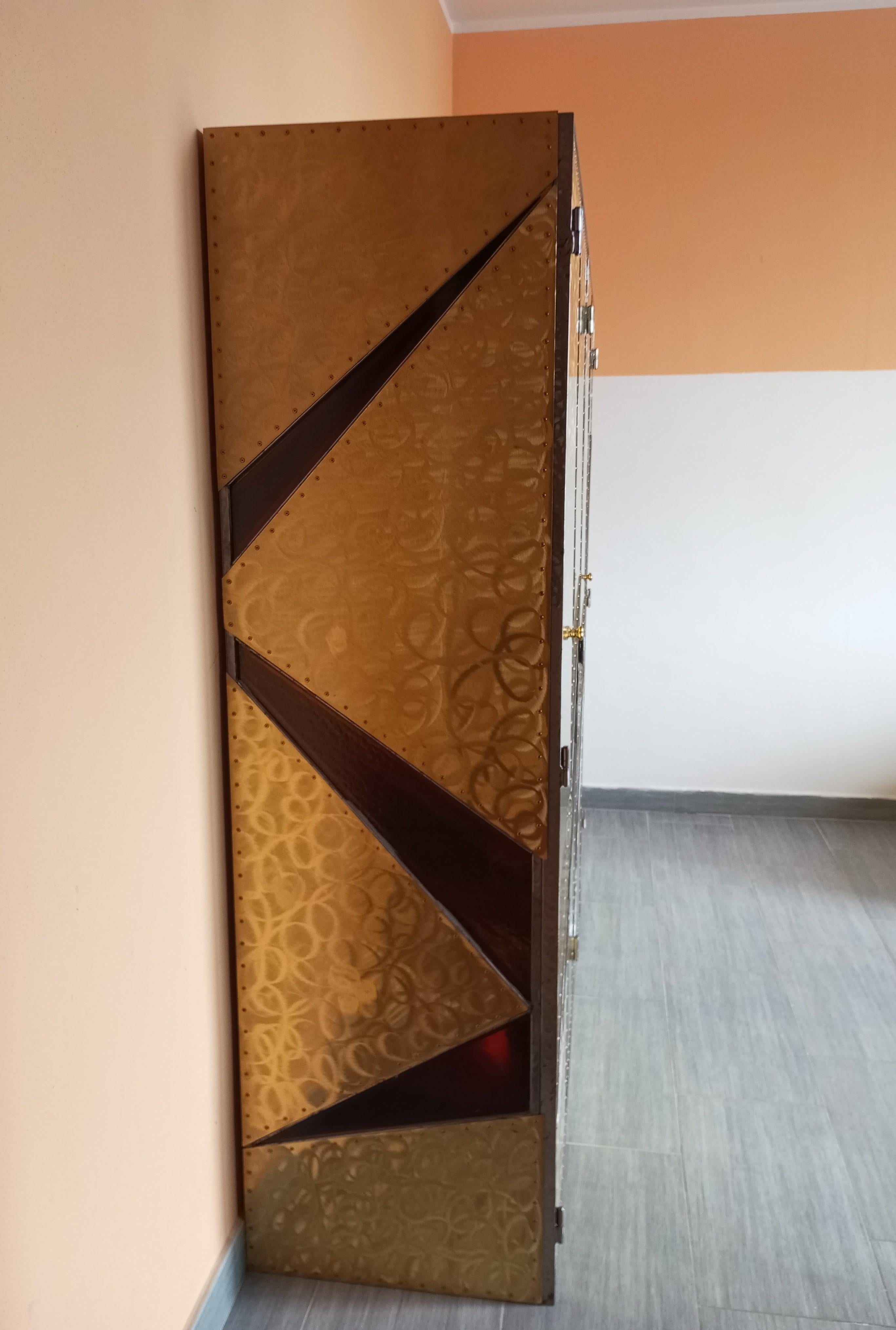 This cabinet represents a perfect balance between tradition and modernity, with the use of classic materials such as brass and steel juxtaposed with high-quality glass, all executed with the skill and attention to detail typical of Italian,